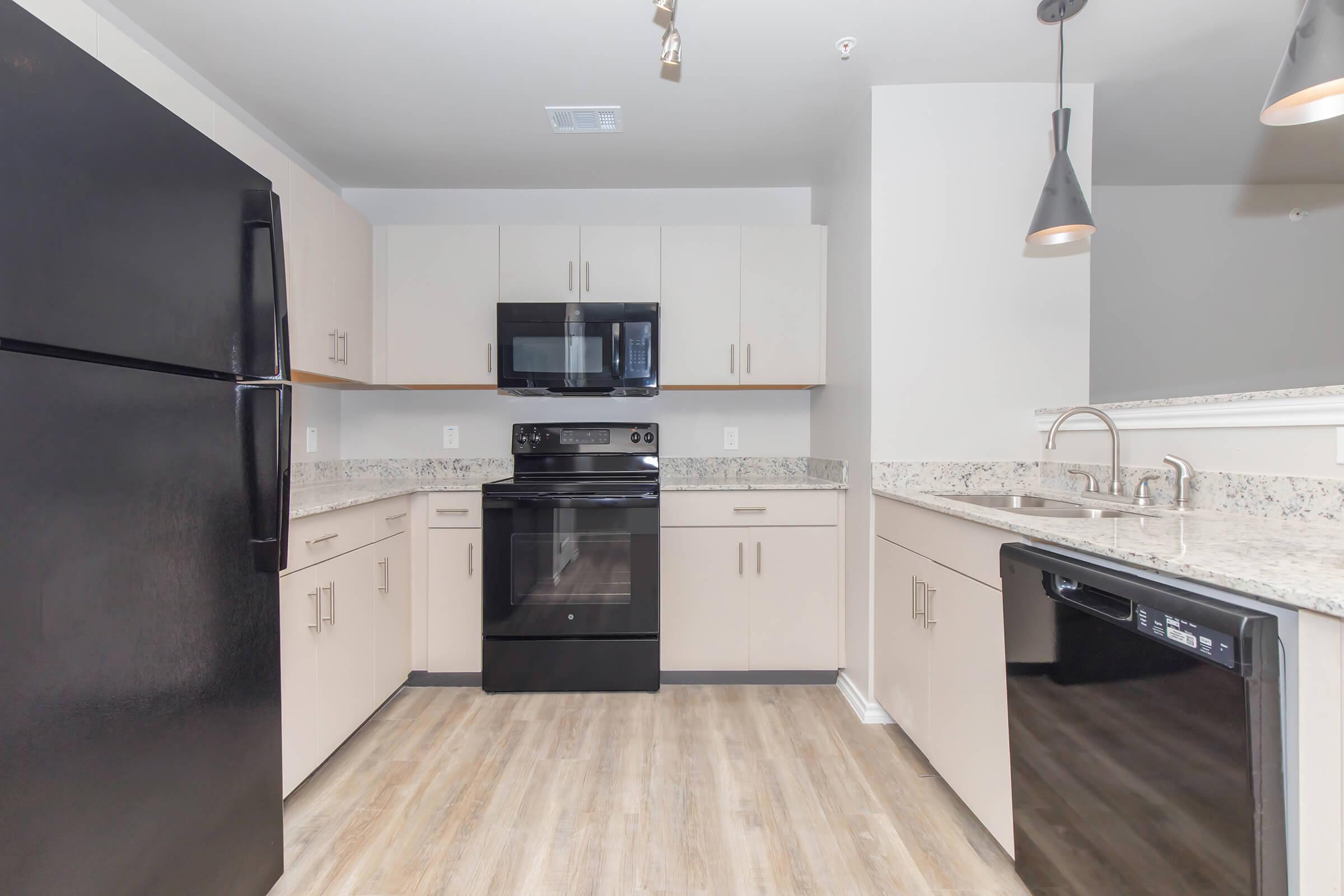 a modern kitchen with stainless steel appliances and wooden cabinets