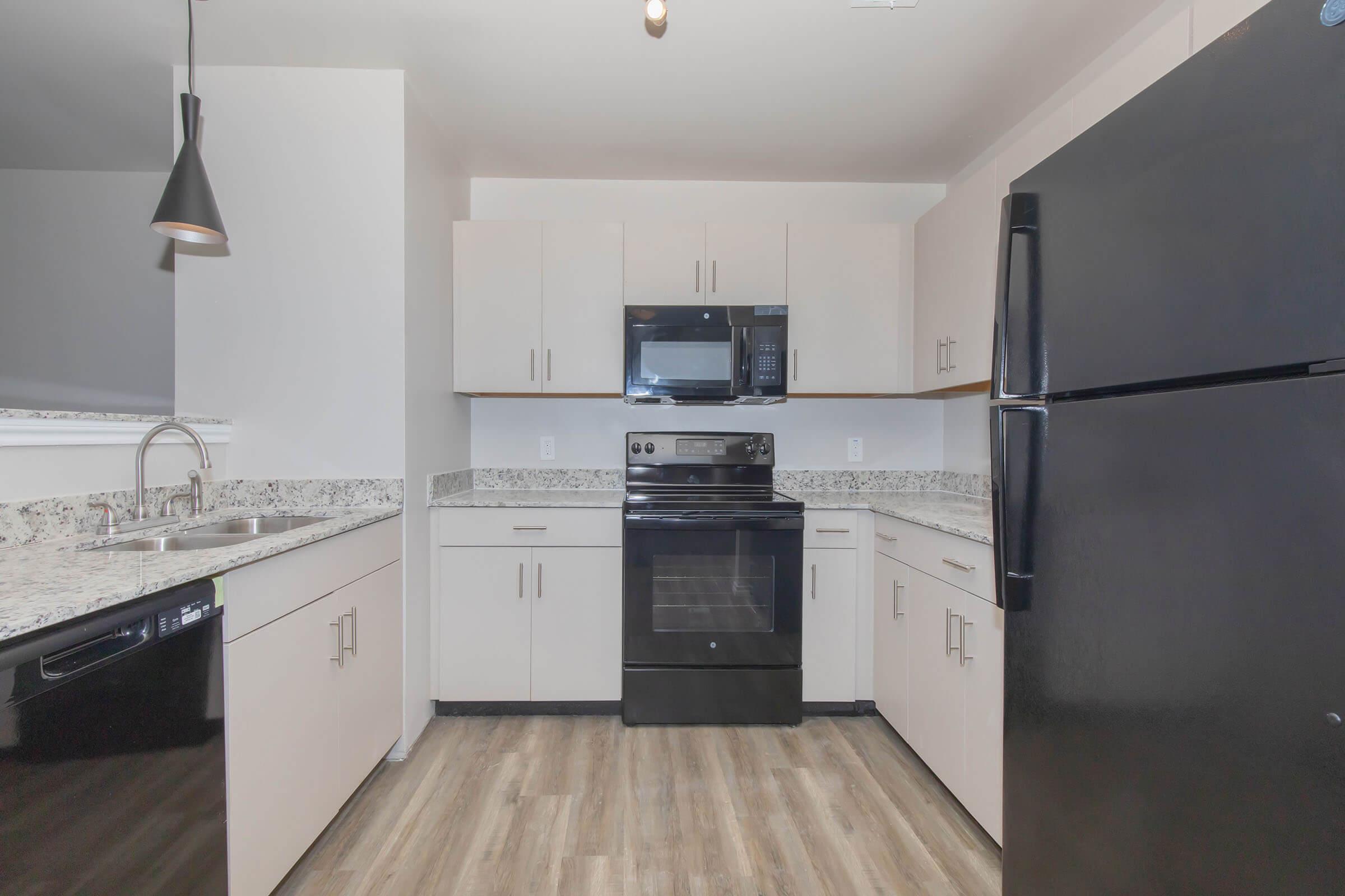 a large kitchen with stainless steel appliances and wooden cabinets