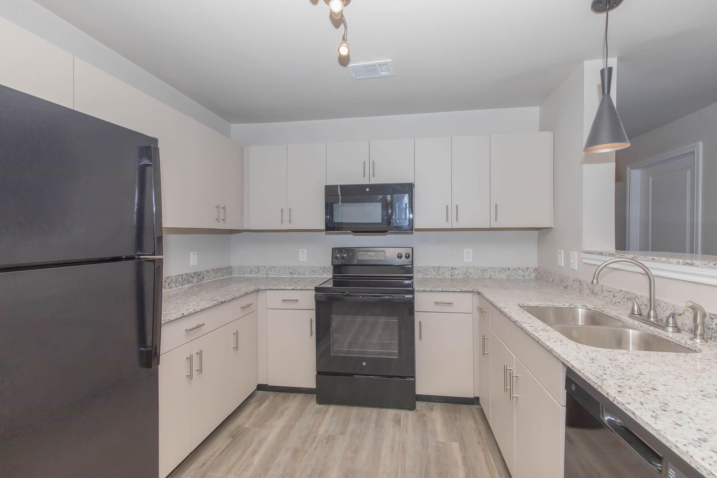 a large kitchen with stainless steel appliances