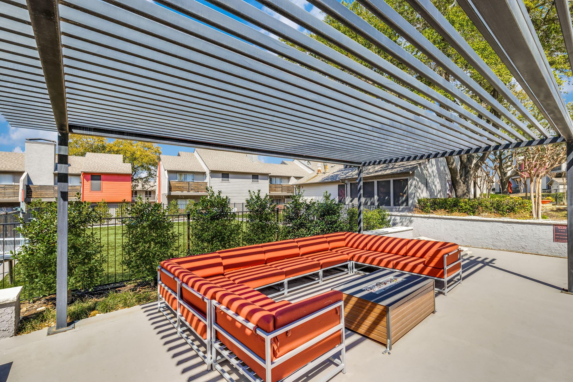 an orange bench in front of a building