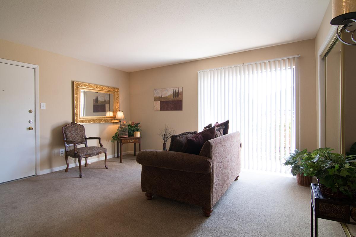 a living room filled with furniture and a flat screen tv