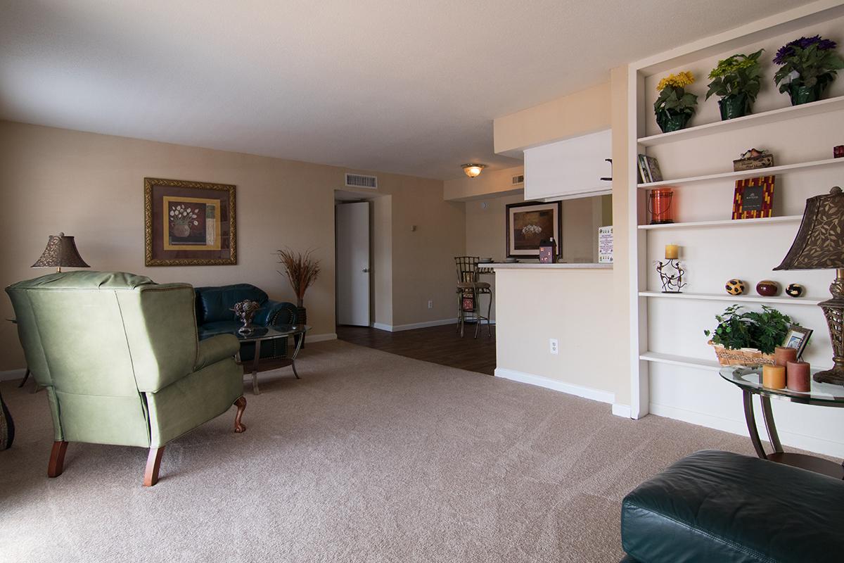 a living room filled with furniture and a flat screen tv