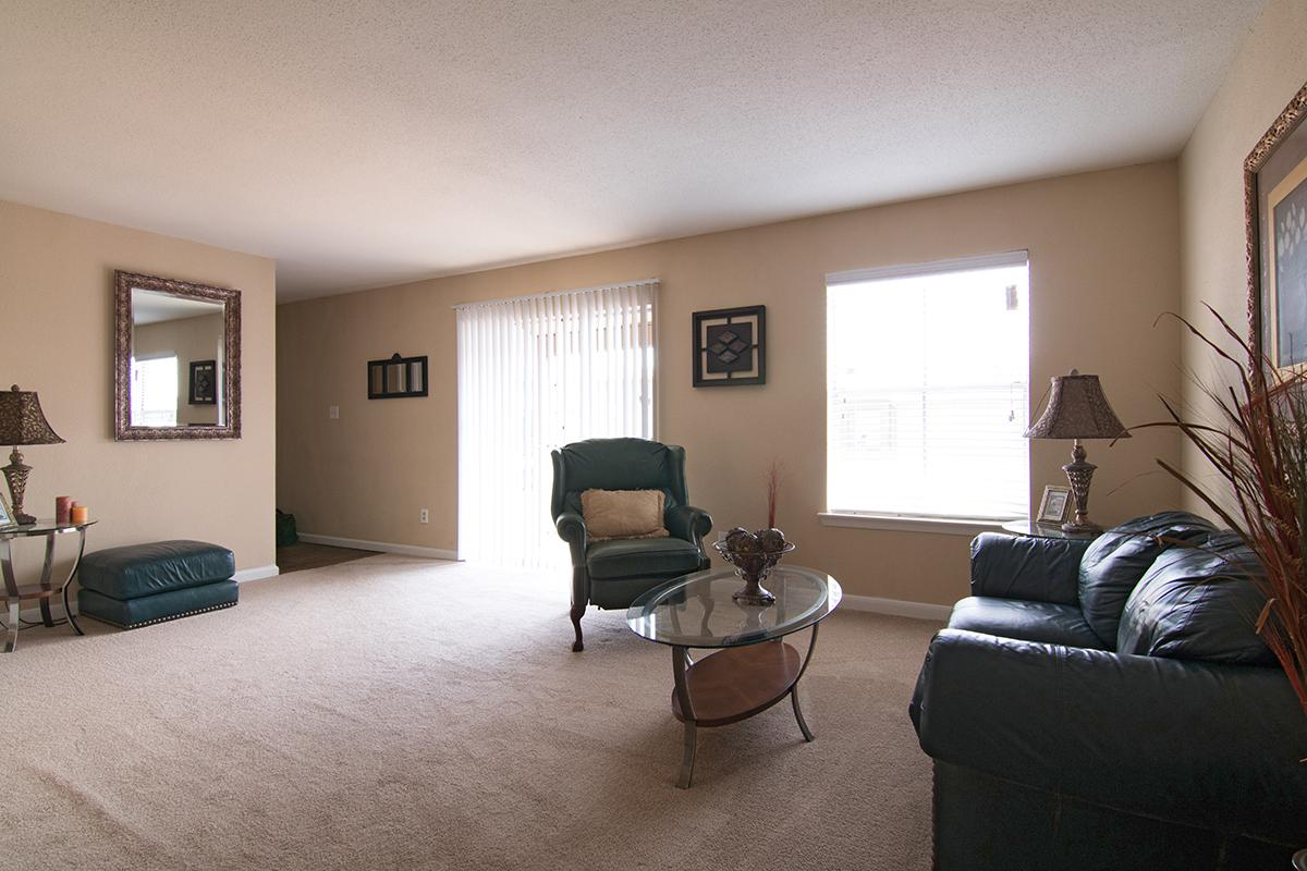 a living room filled with furniture and a large window