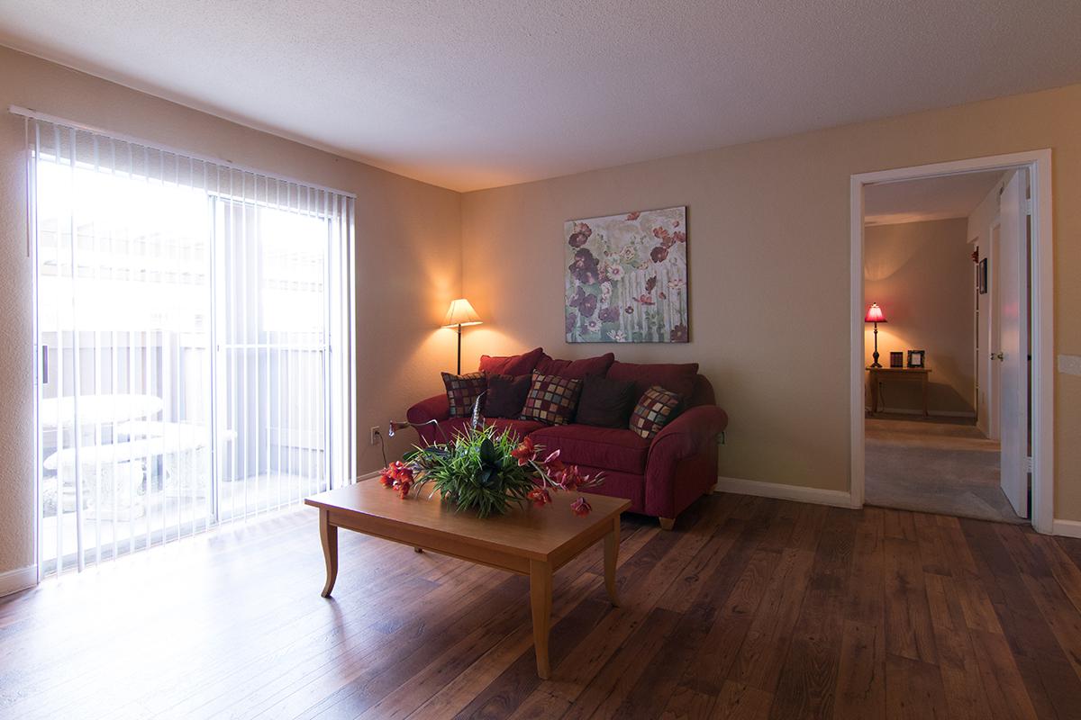 a living room filled with furniture and a large window