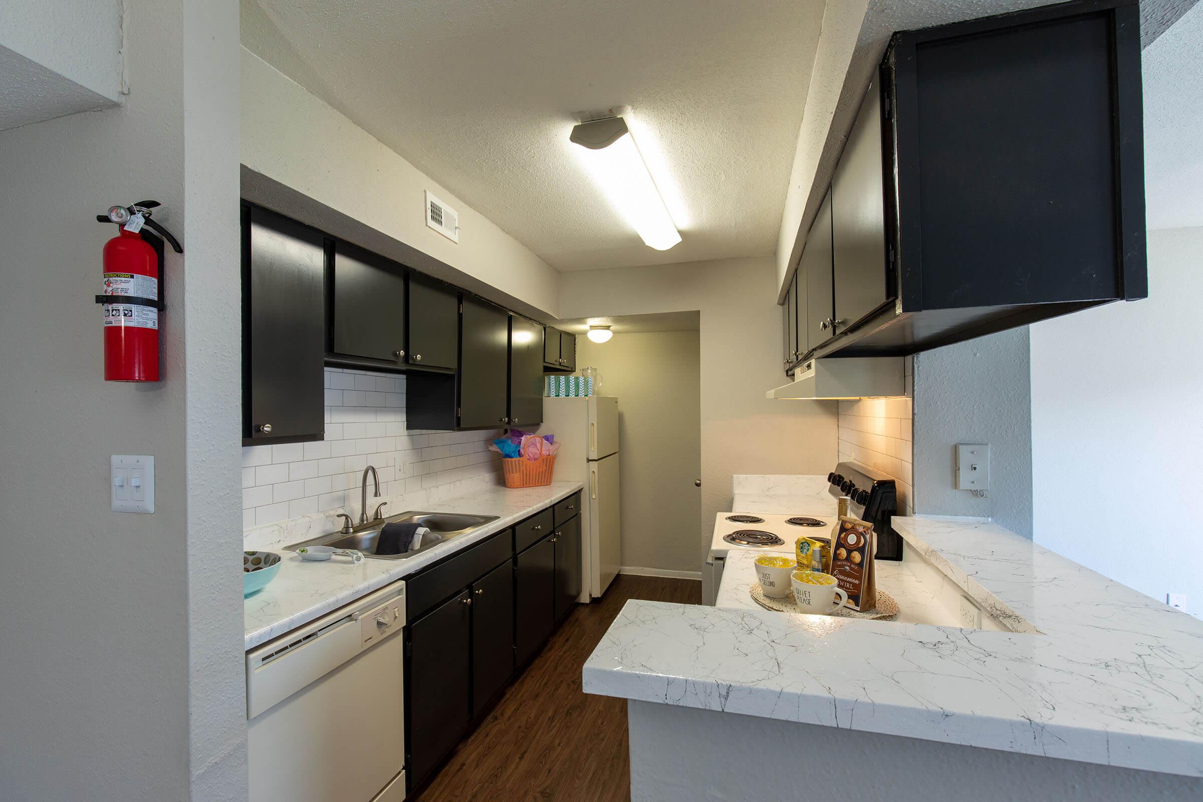 a kitchen with a sink and a mirror