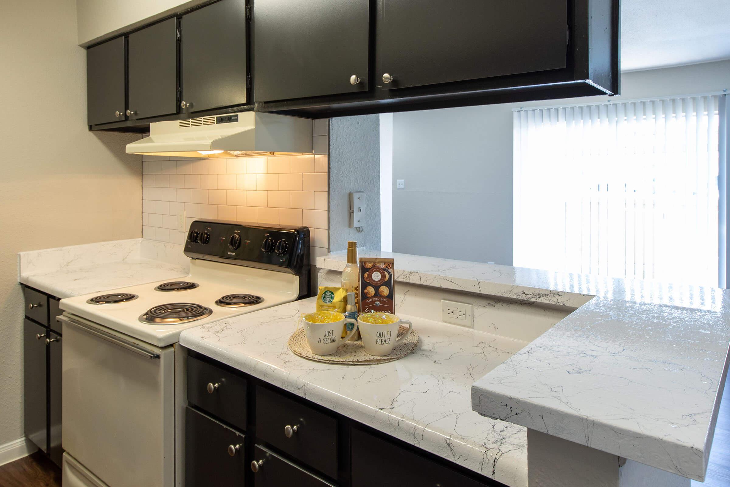 a kitchen with a sink and a mirror