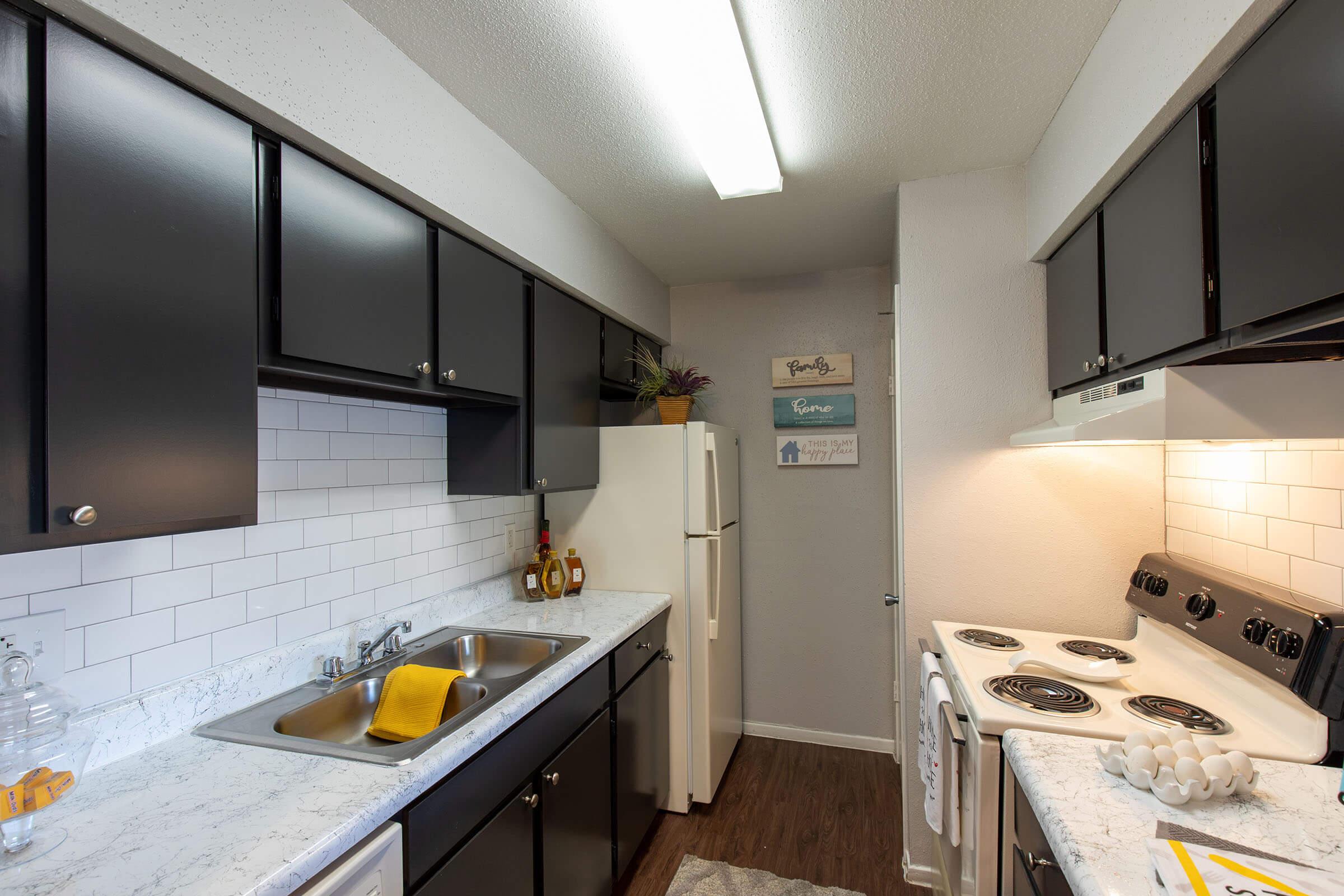 a kitchen with a sink and a mirror