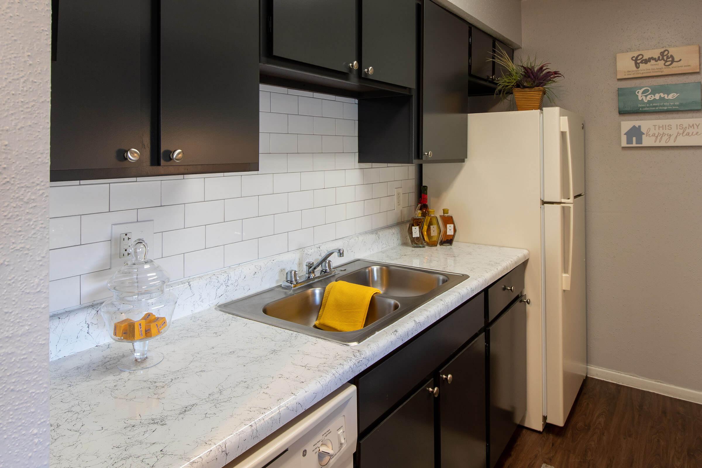 a kitchen with a sink and a mirror