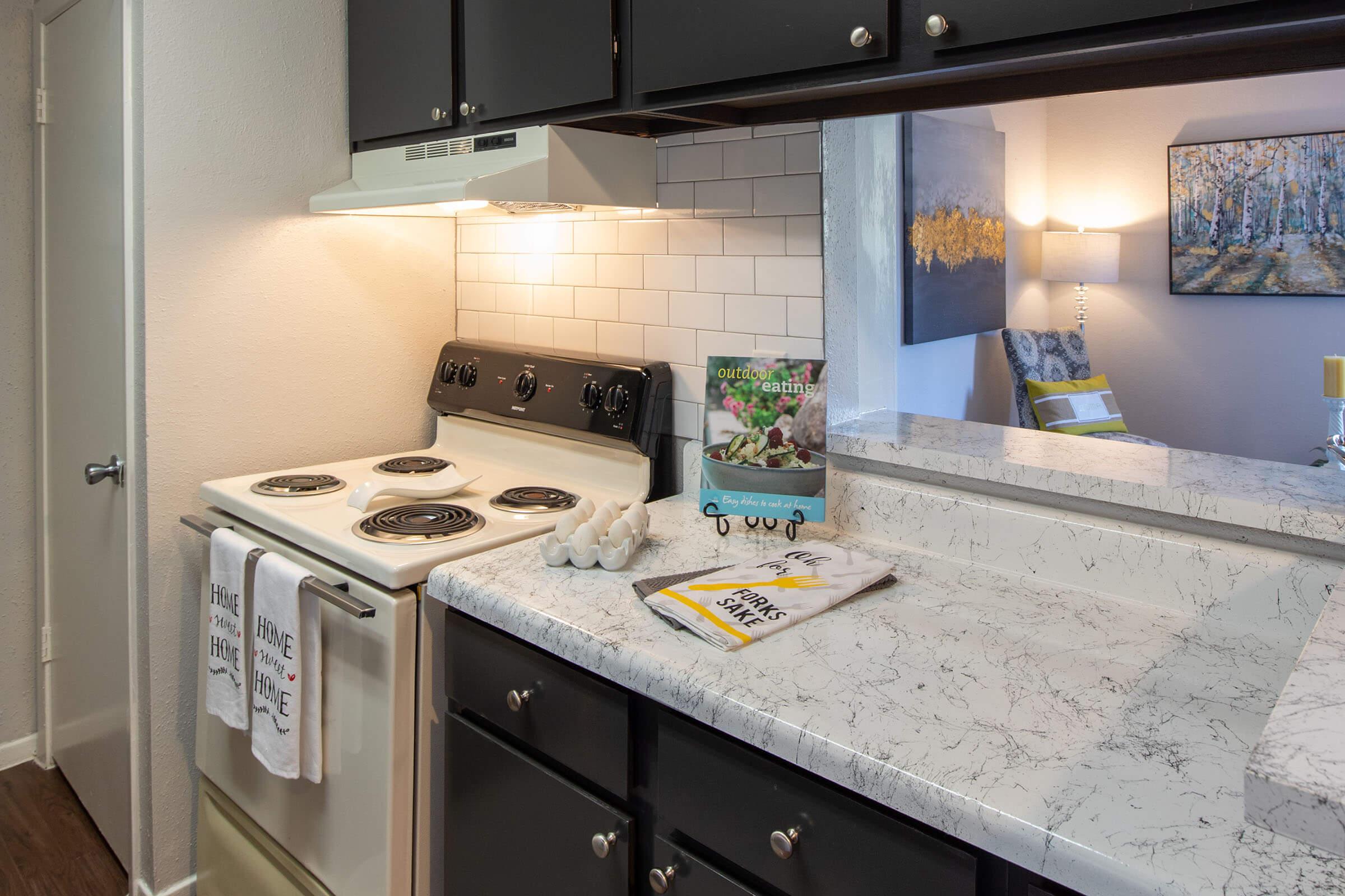 a stove top oven sitting inside of a kitchen