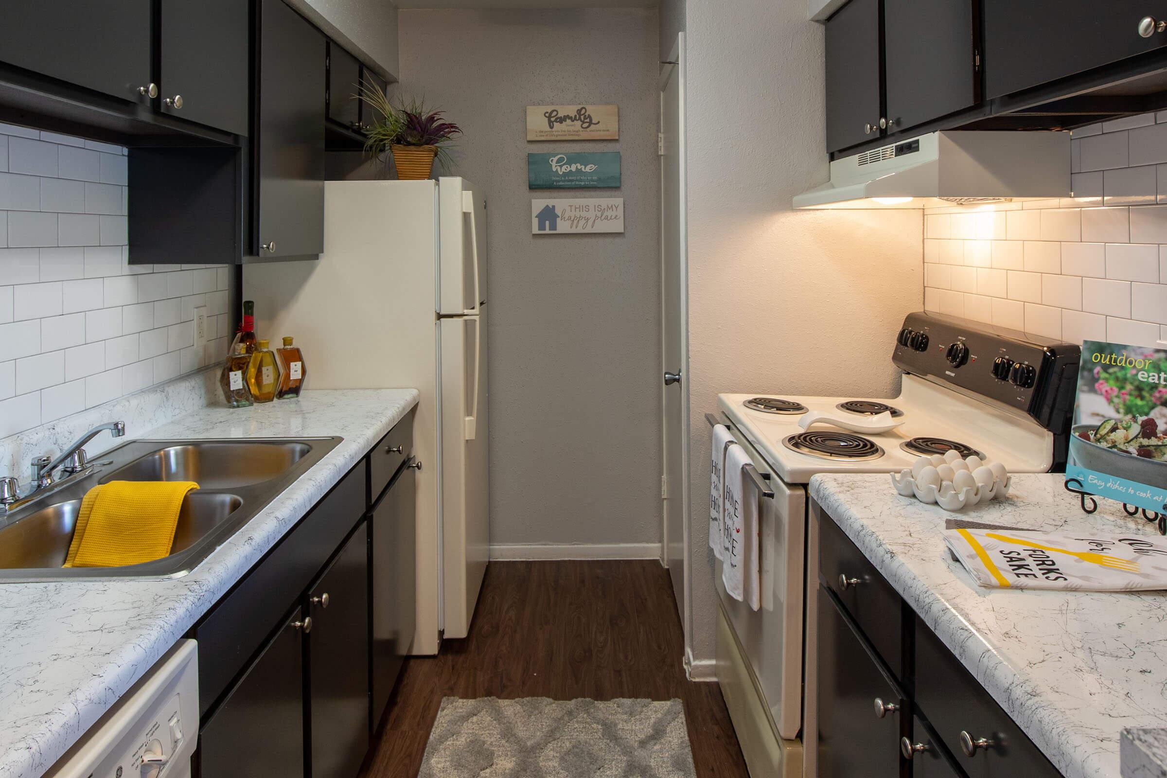 a kitchen with a sink and a refrigerator