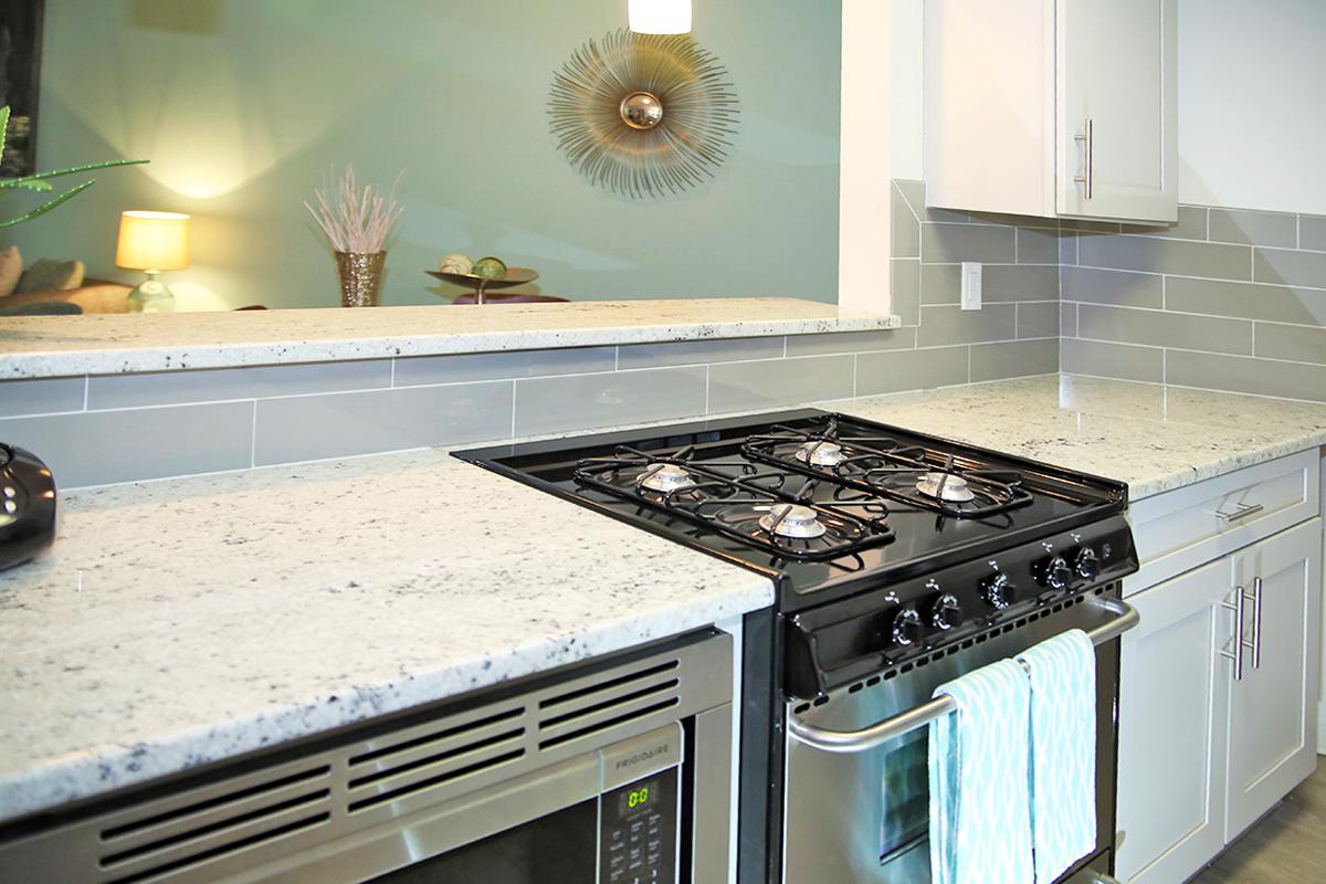 a stove top oven sitting inside of a kitchen