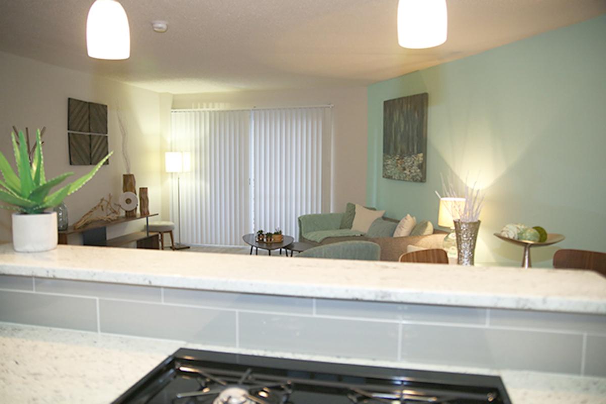 a kitchen with a stove a sink and a window