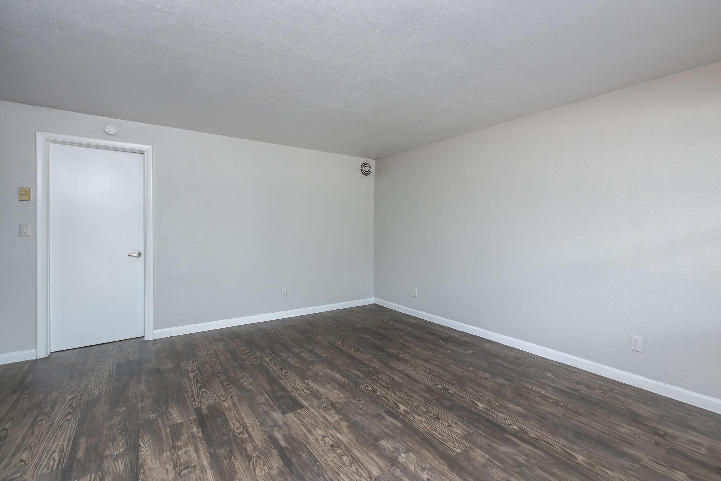 a bedroom with a wooden floor