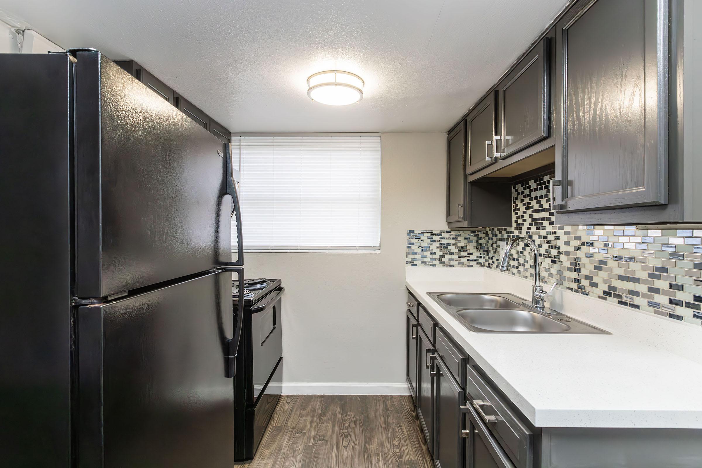 a kitchen with a sink and a refrigerator