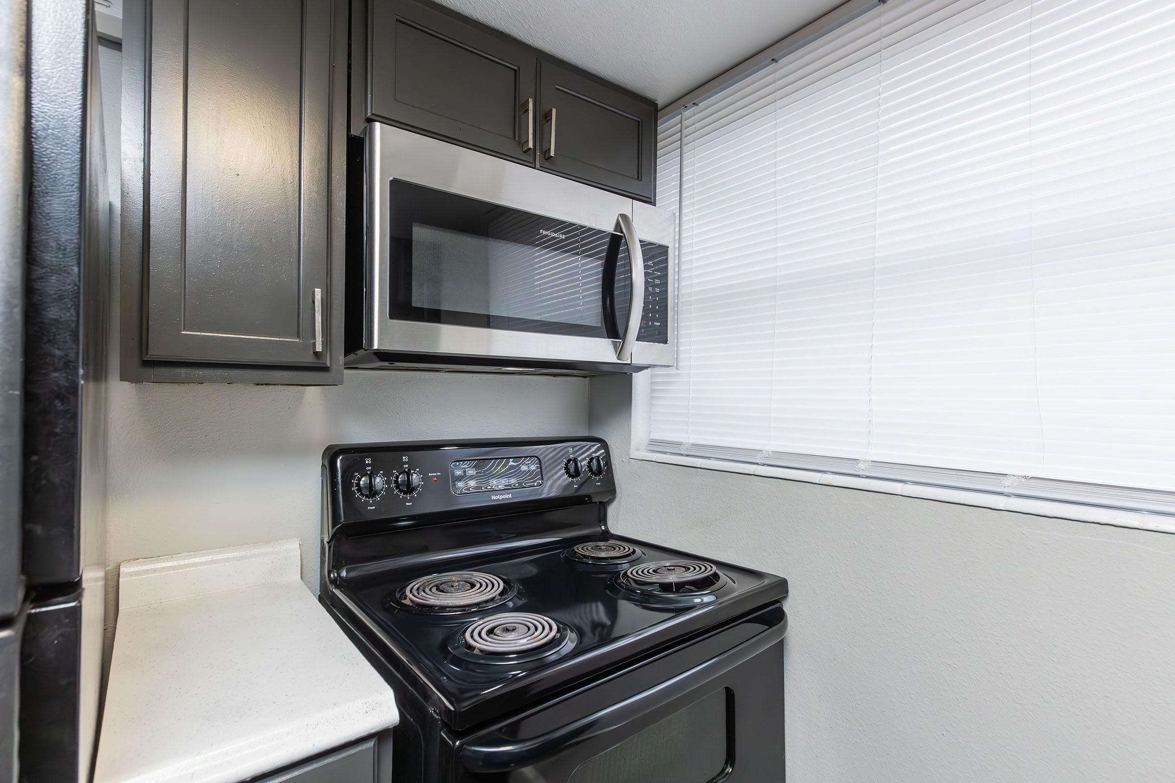 a stove top oven sitting inside of a kitchen