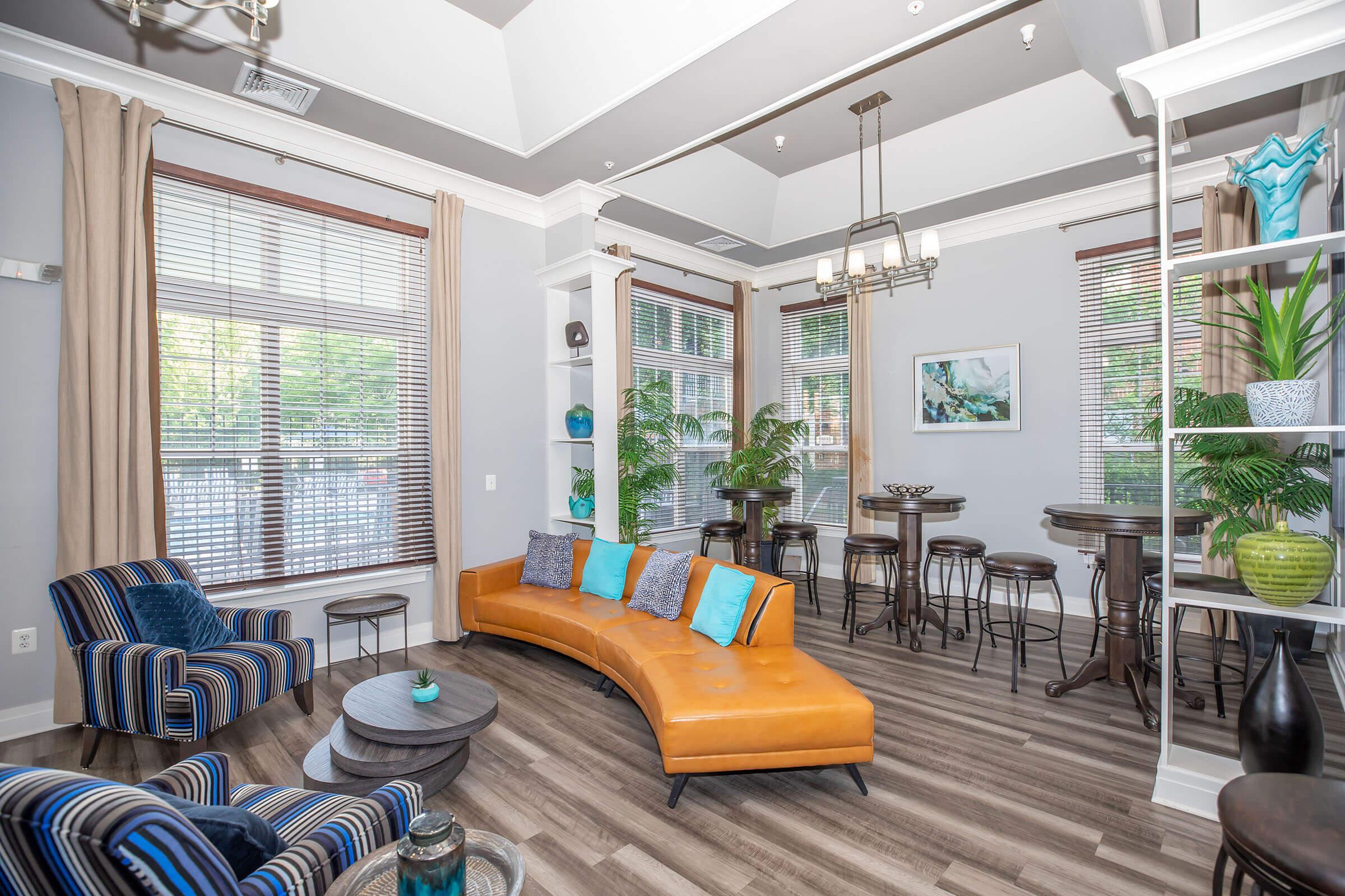 a living room filled with furniture and a large window