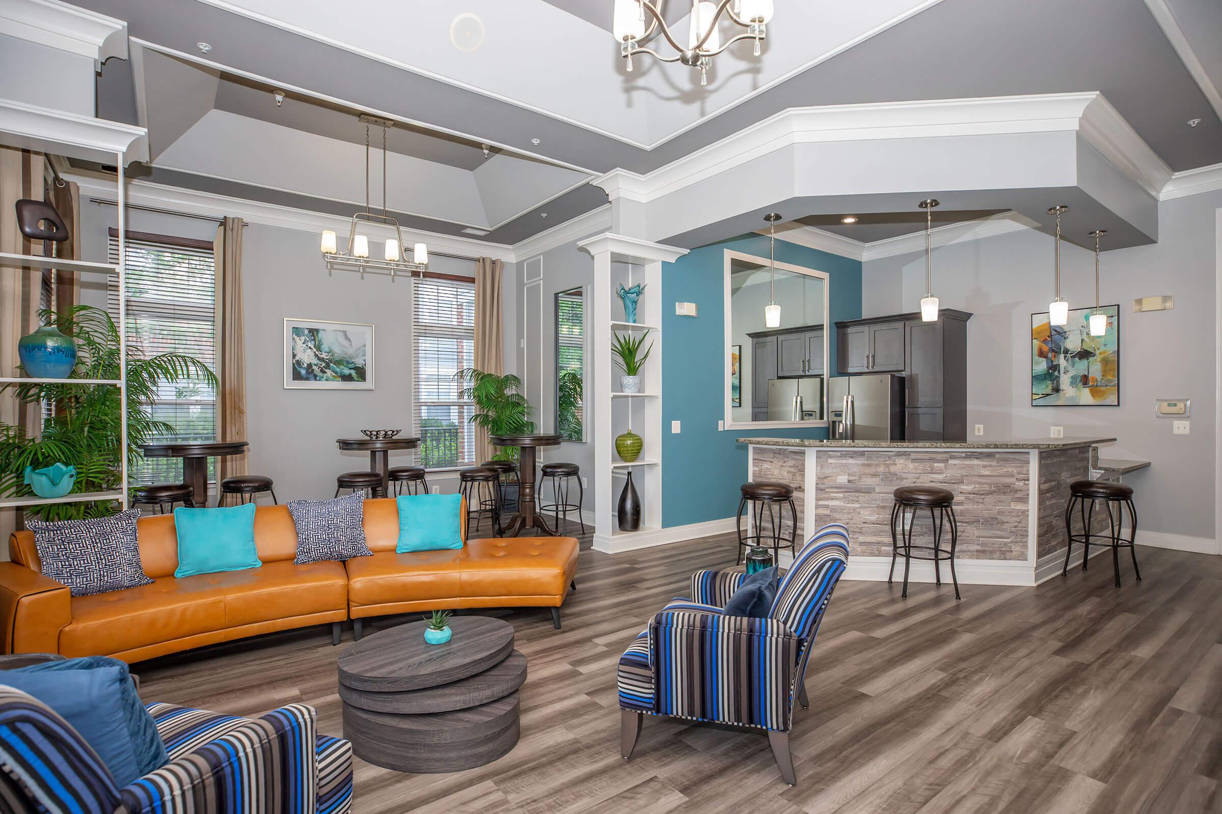 a living room filled with furniture on top of a wooden floor