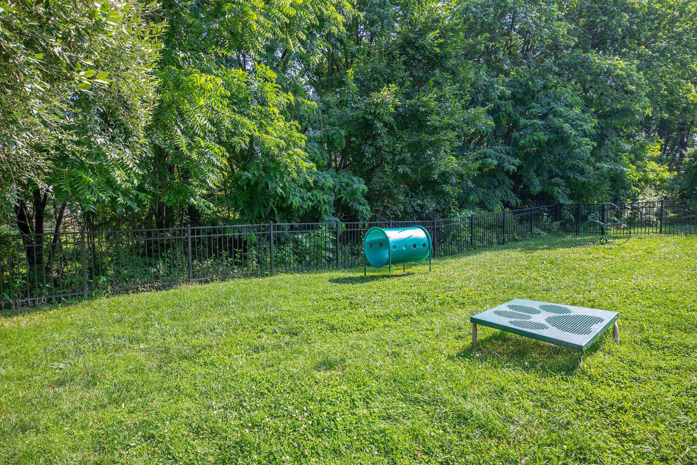 a couple of lawn chairs sitting on top of a grass covered field