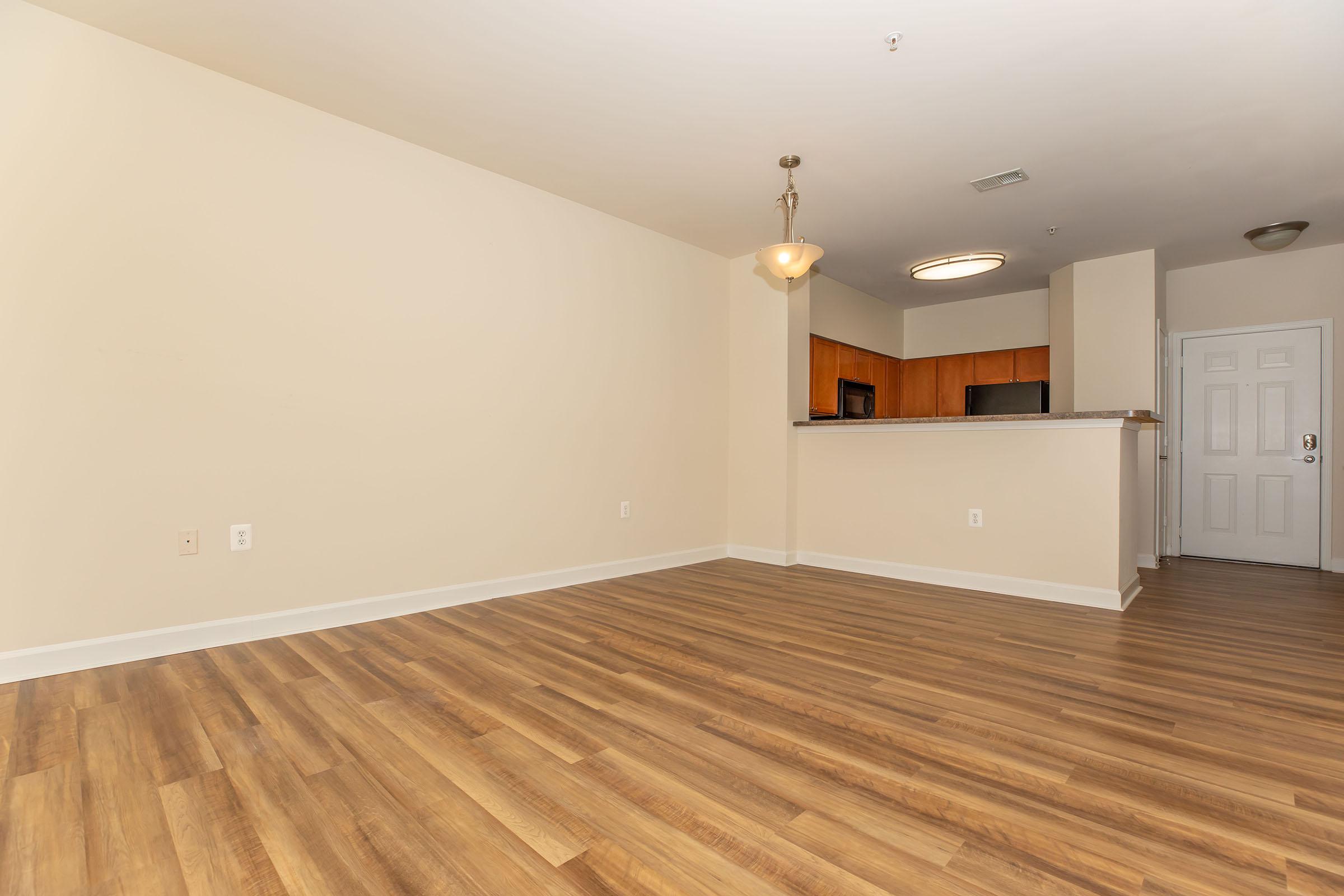 a large empty room with a wood floor