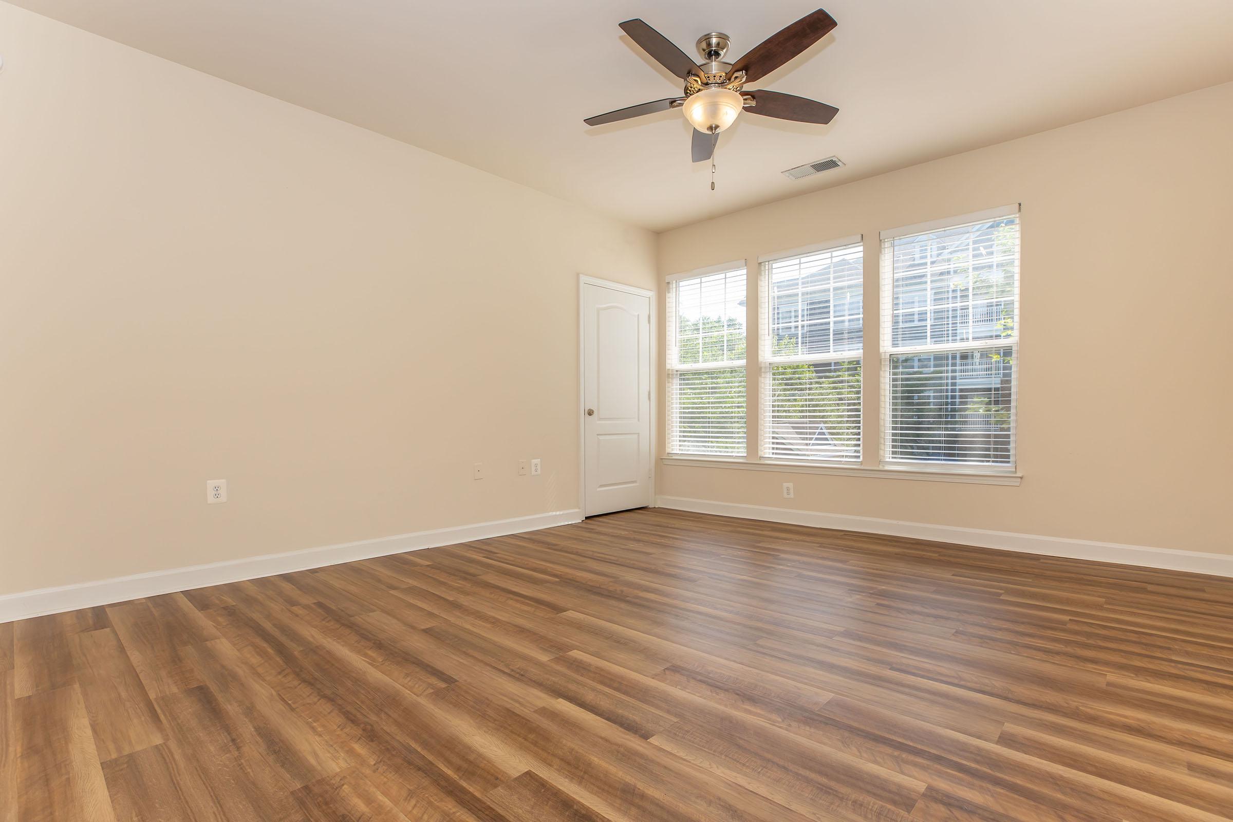 a large empty room with a wood floor