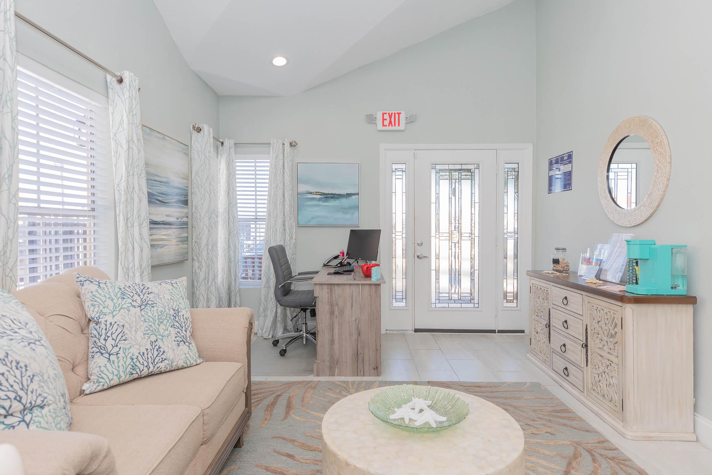 a living room filled with furniture and a large window