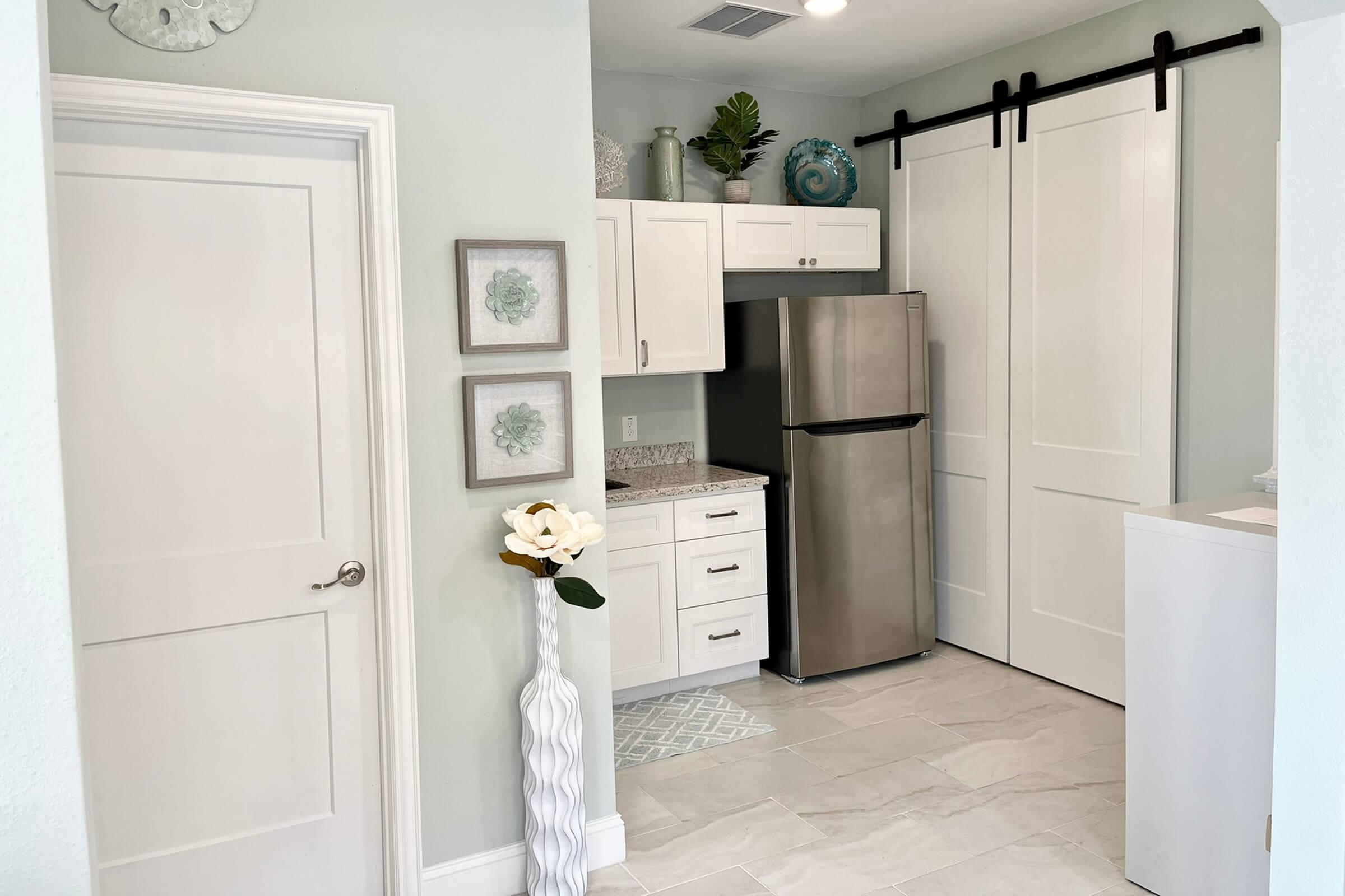 a kitchen with a sink and a refrigerator