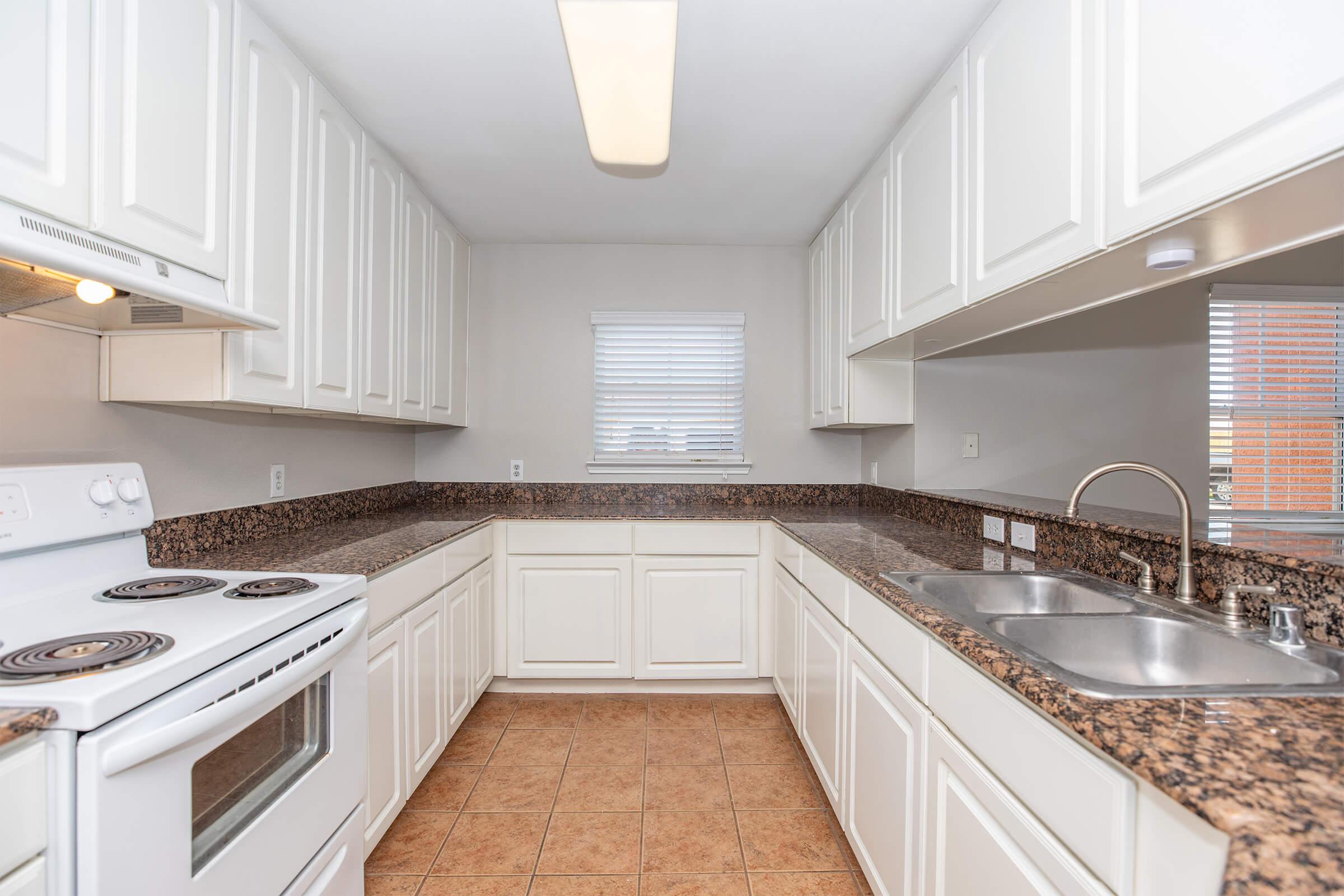 a kitchen with a stove top oven