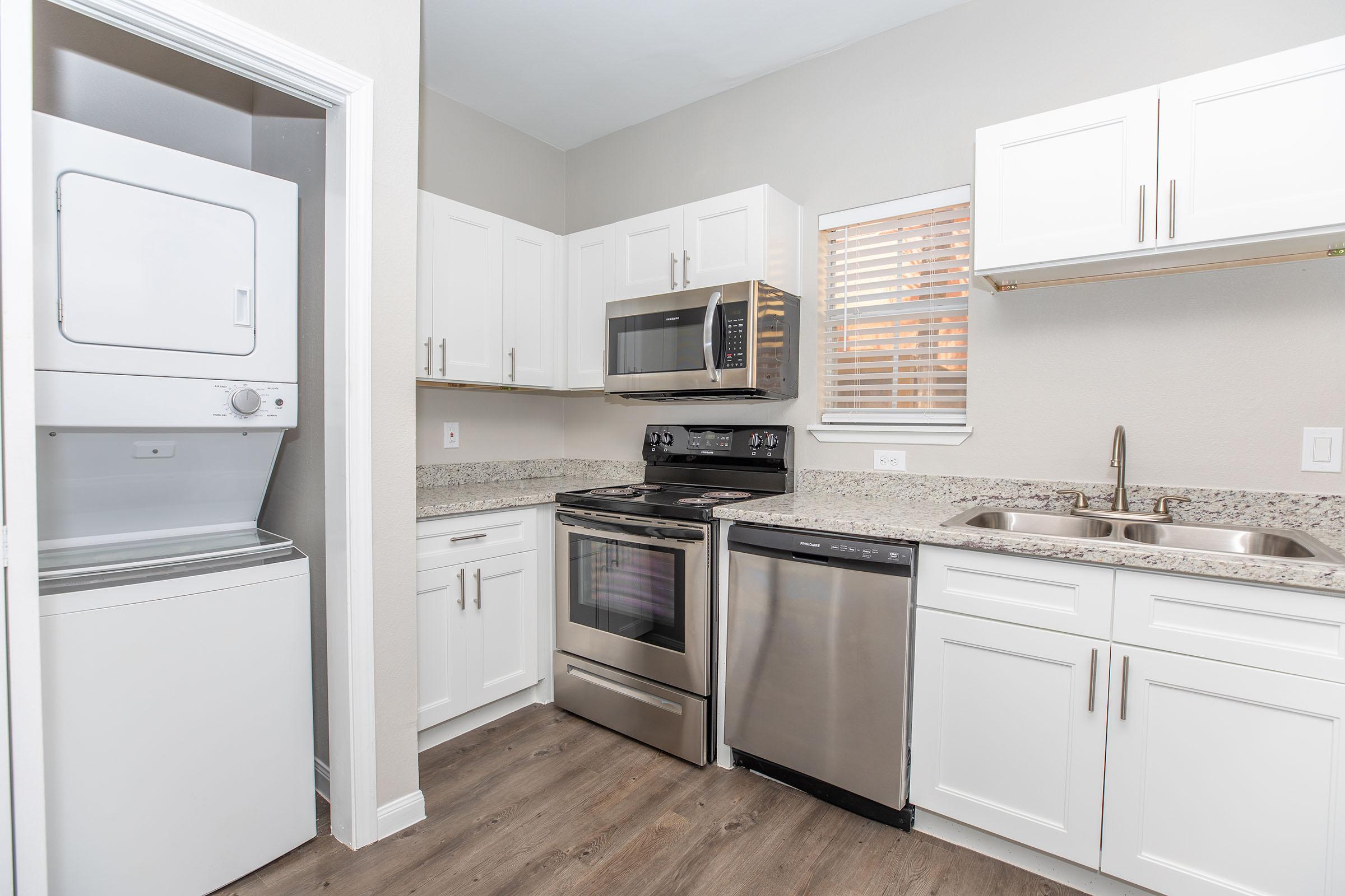 a kitchen with a stove and a refrigerator