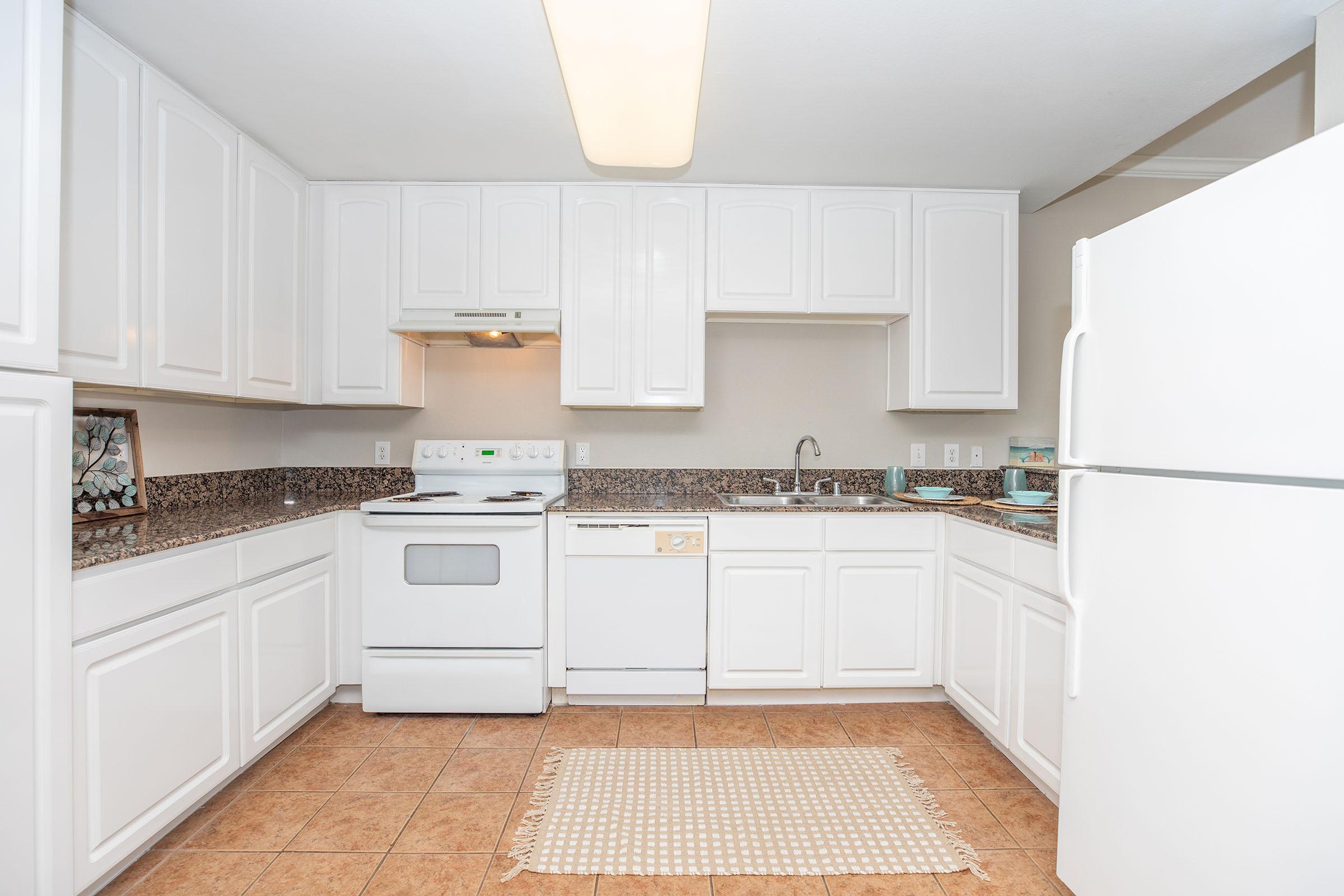 a kitchen with a stove and a refrigerator