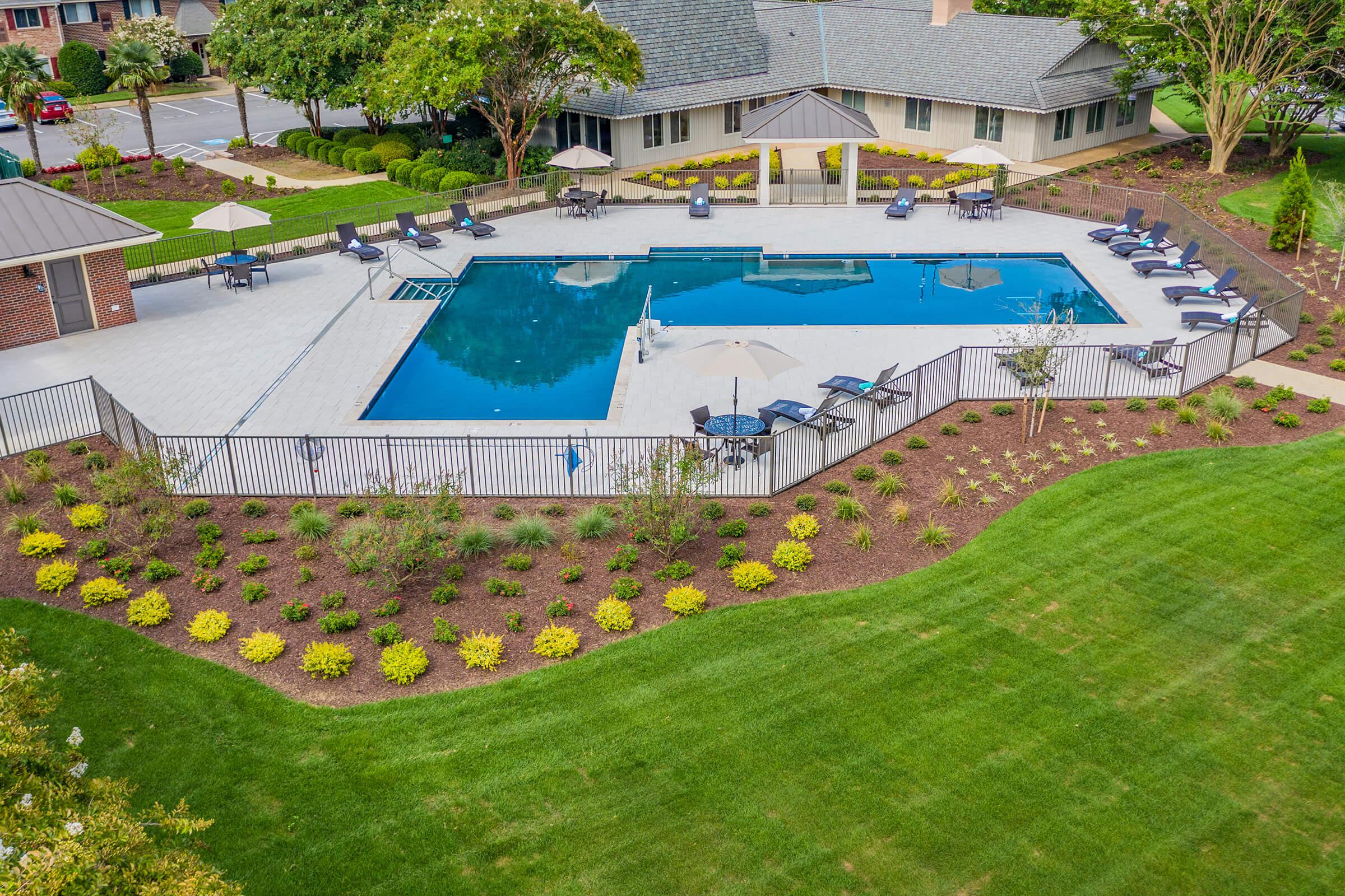 a large lawn in front of a pool