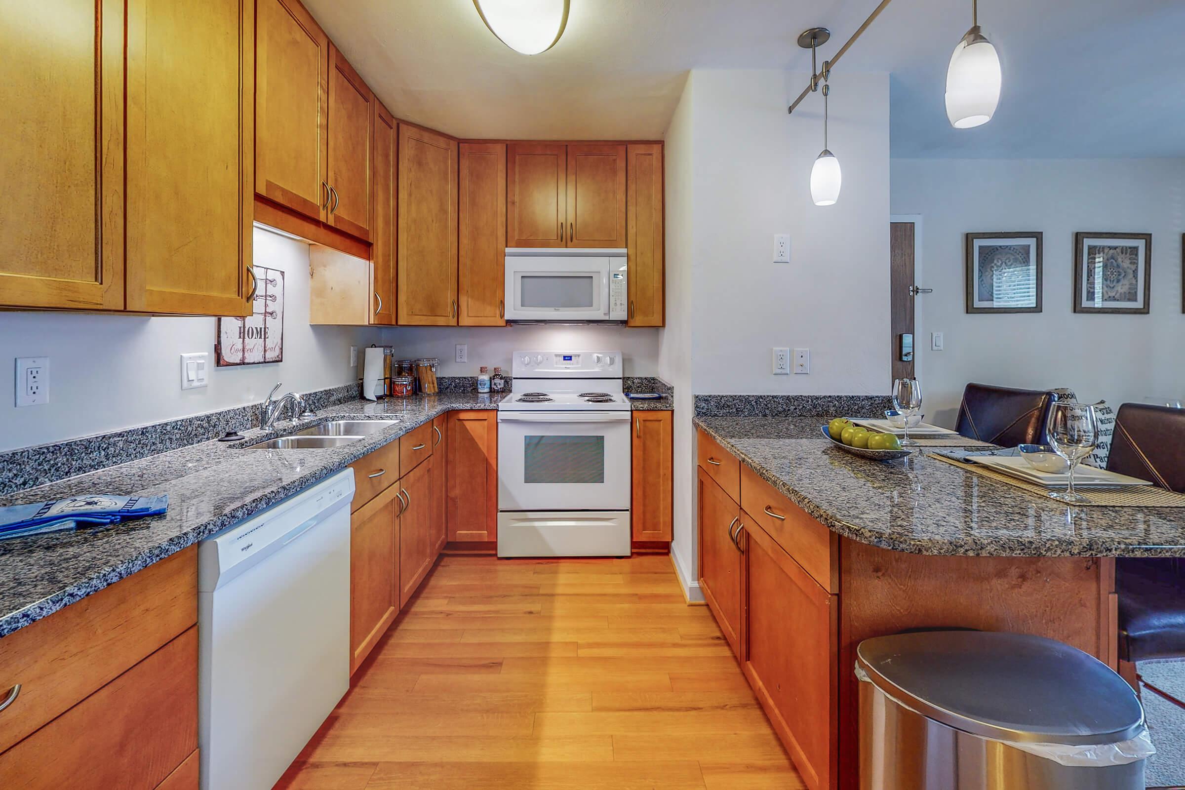 a modern kitchen with stainless steel appliances and wooden cabinets
