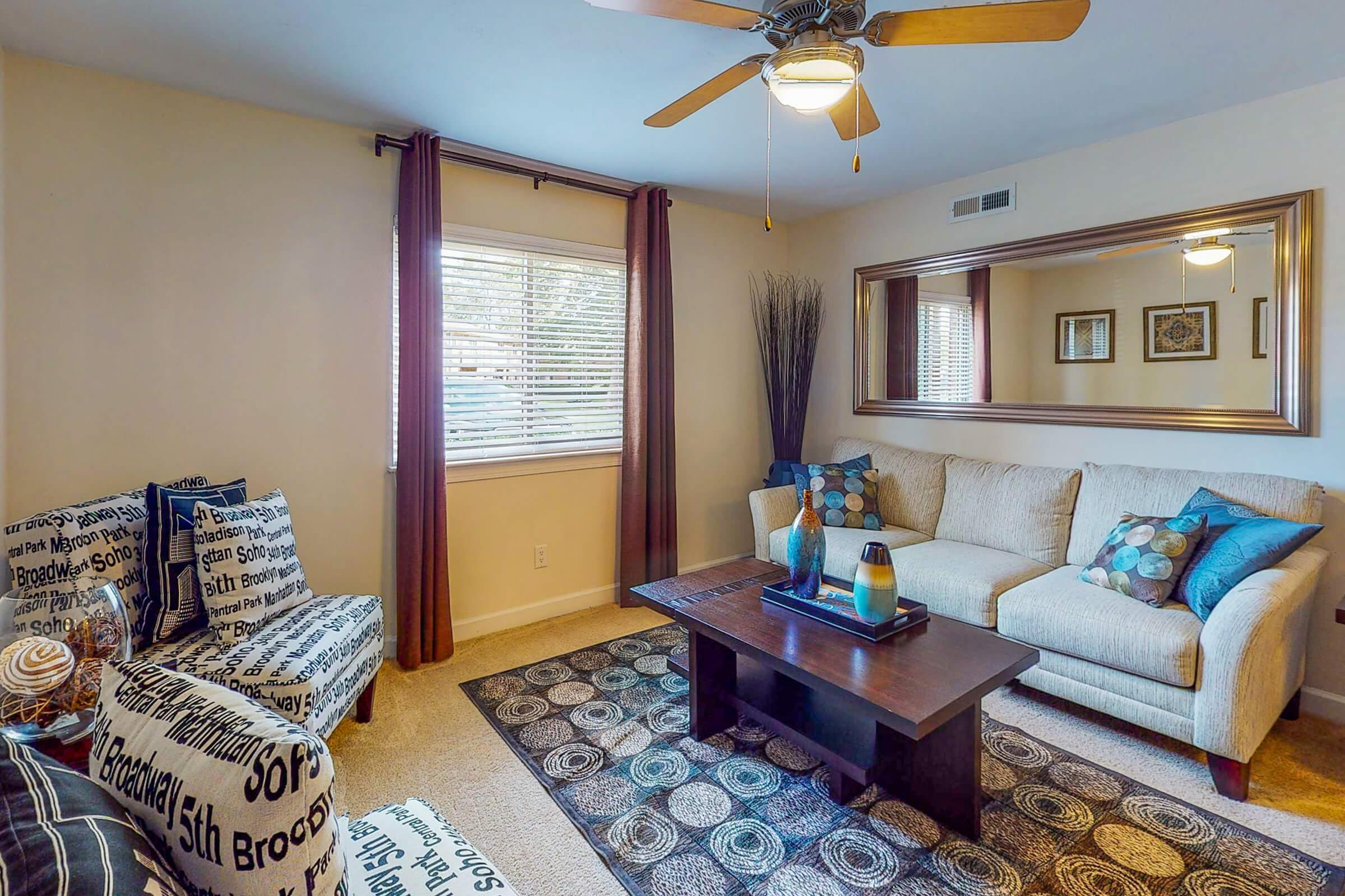 a living room filled with furniture and a large window