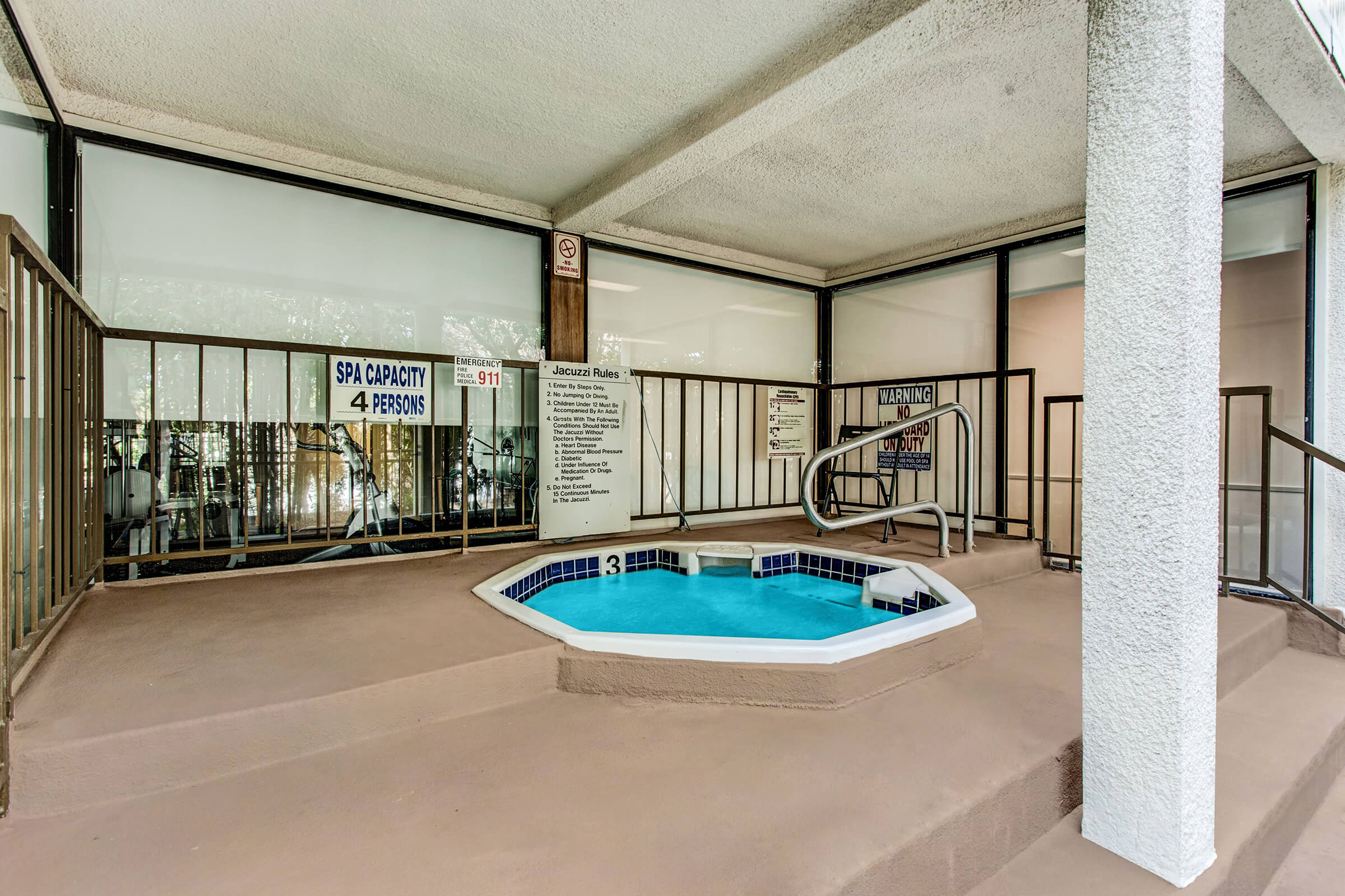 a room with a pool in front of a building