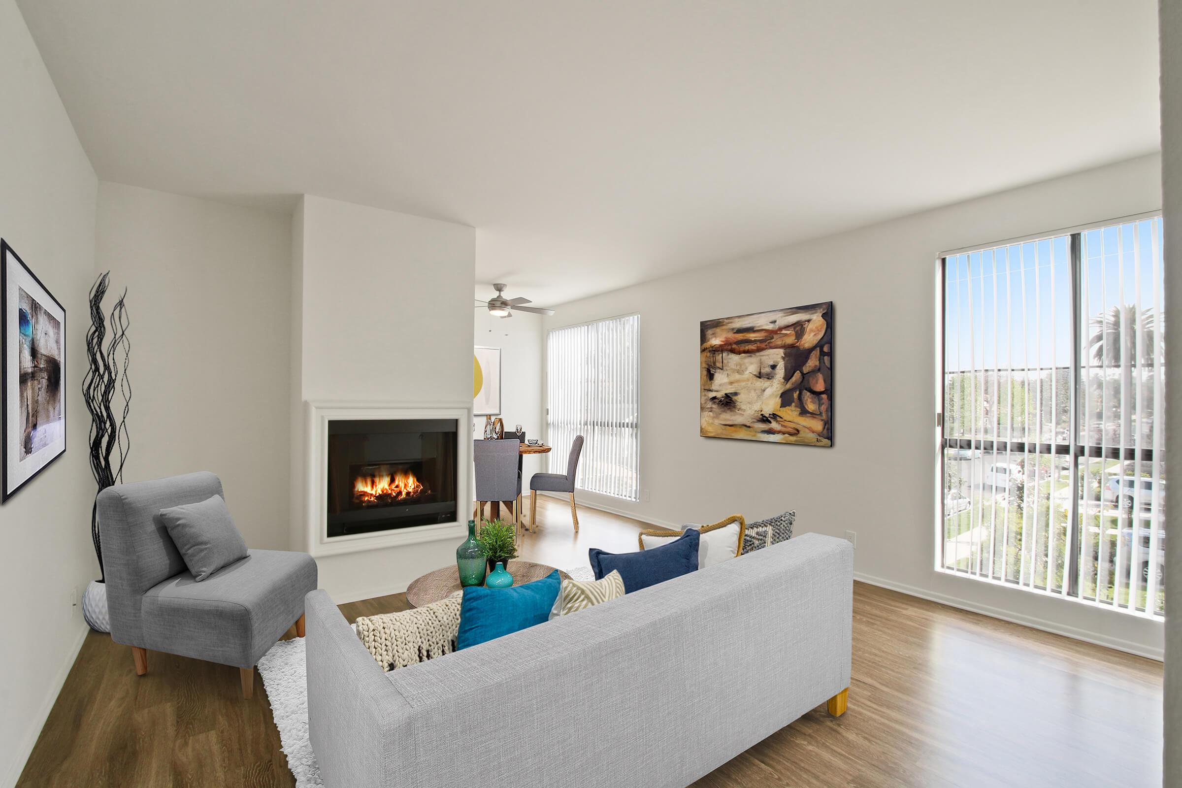 a living room filled with furniture and a large window