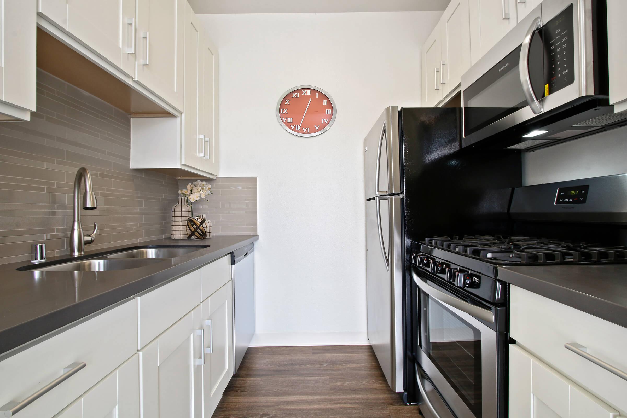 a kitchen with stainless steel appliances and wooden cabinets