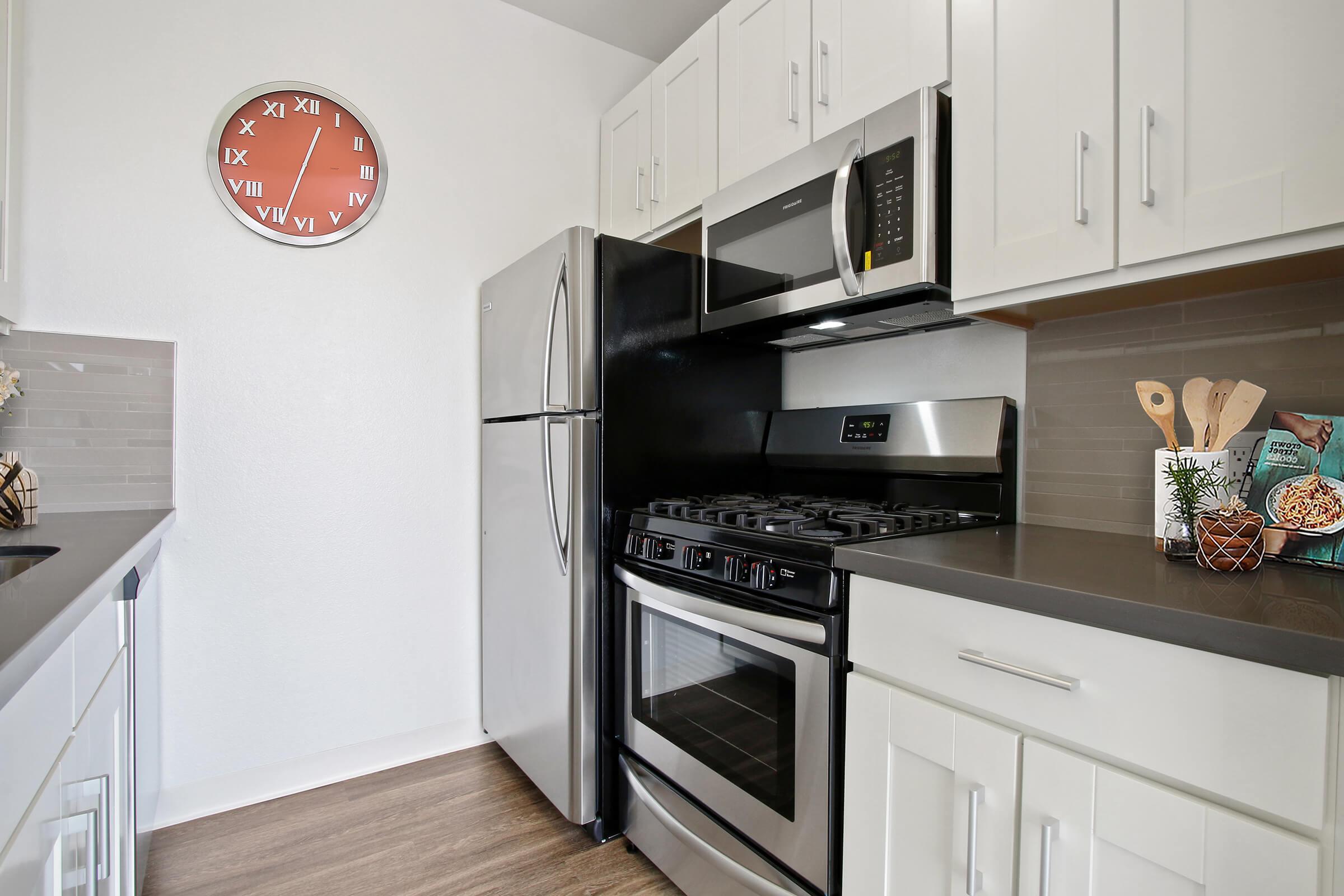 a stove top oven sitting inside of a kitchen