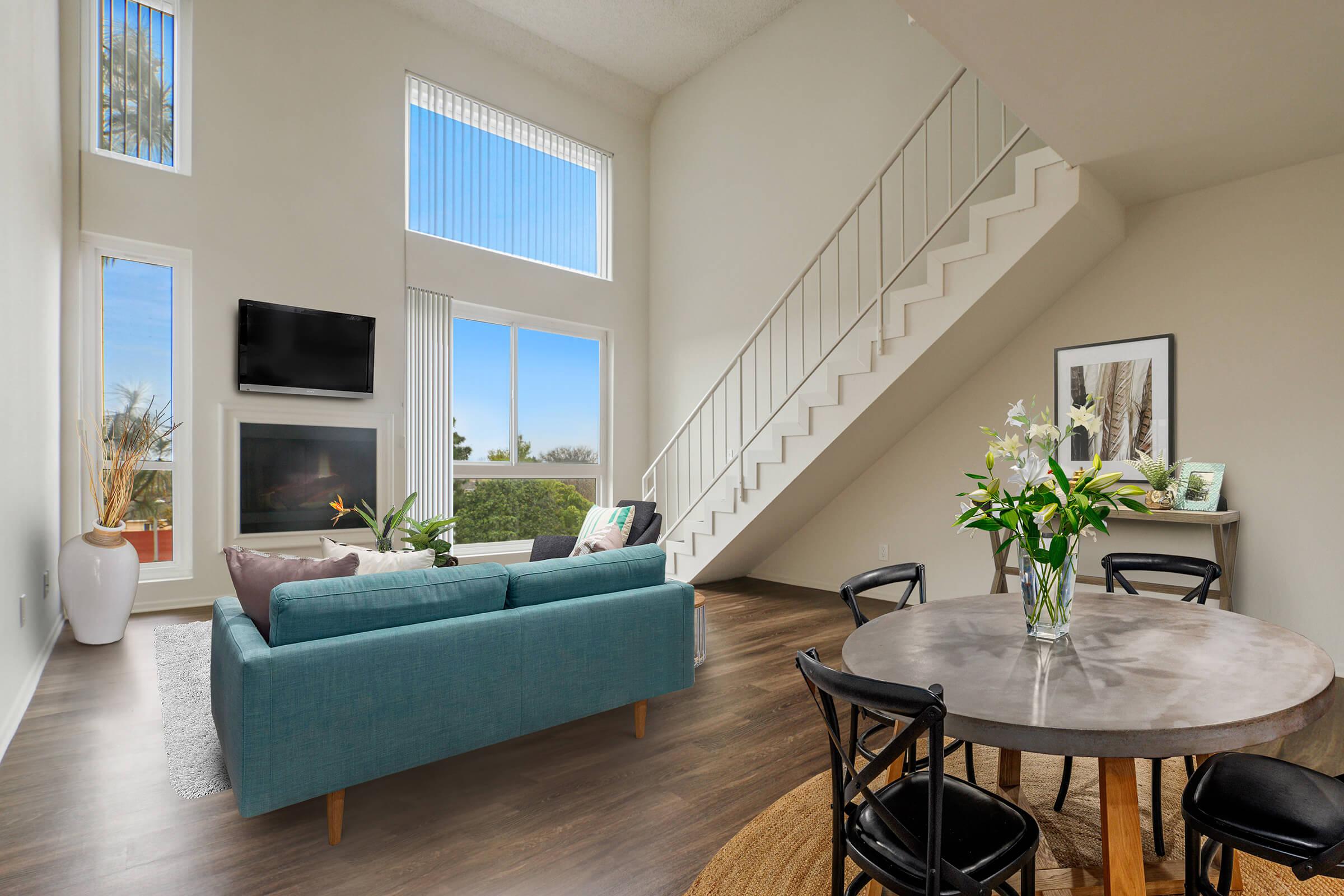 a living room filled with furniture and a large window