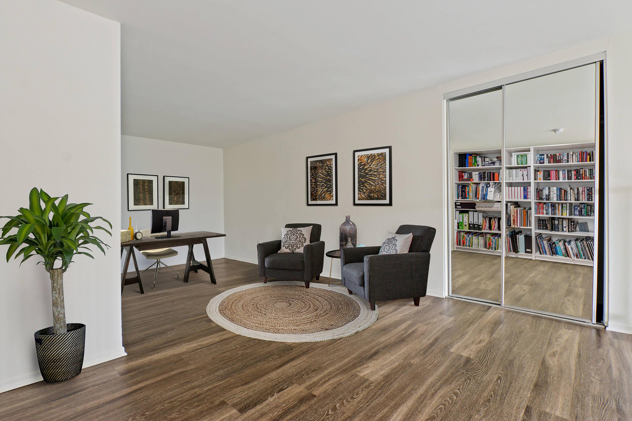 a living room filled with furniture and a tv