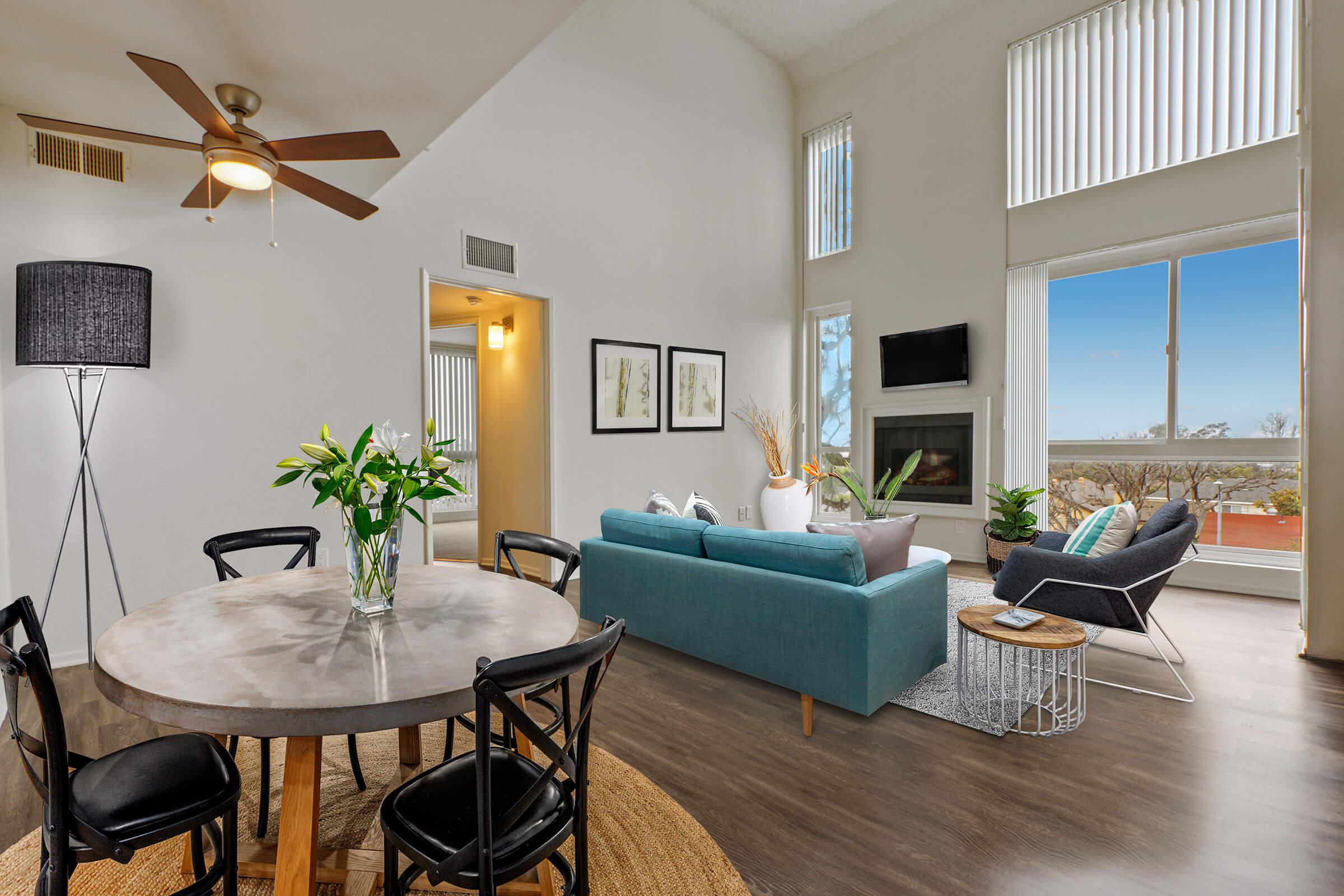 a living room filled with furniture and a large window