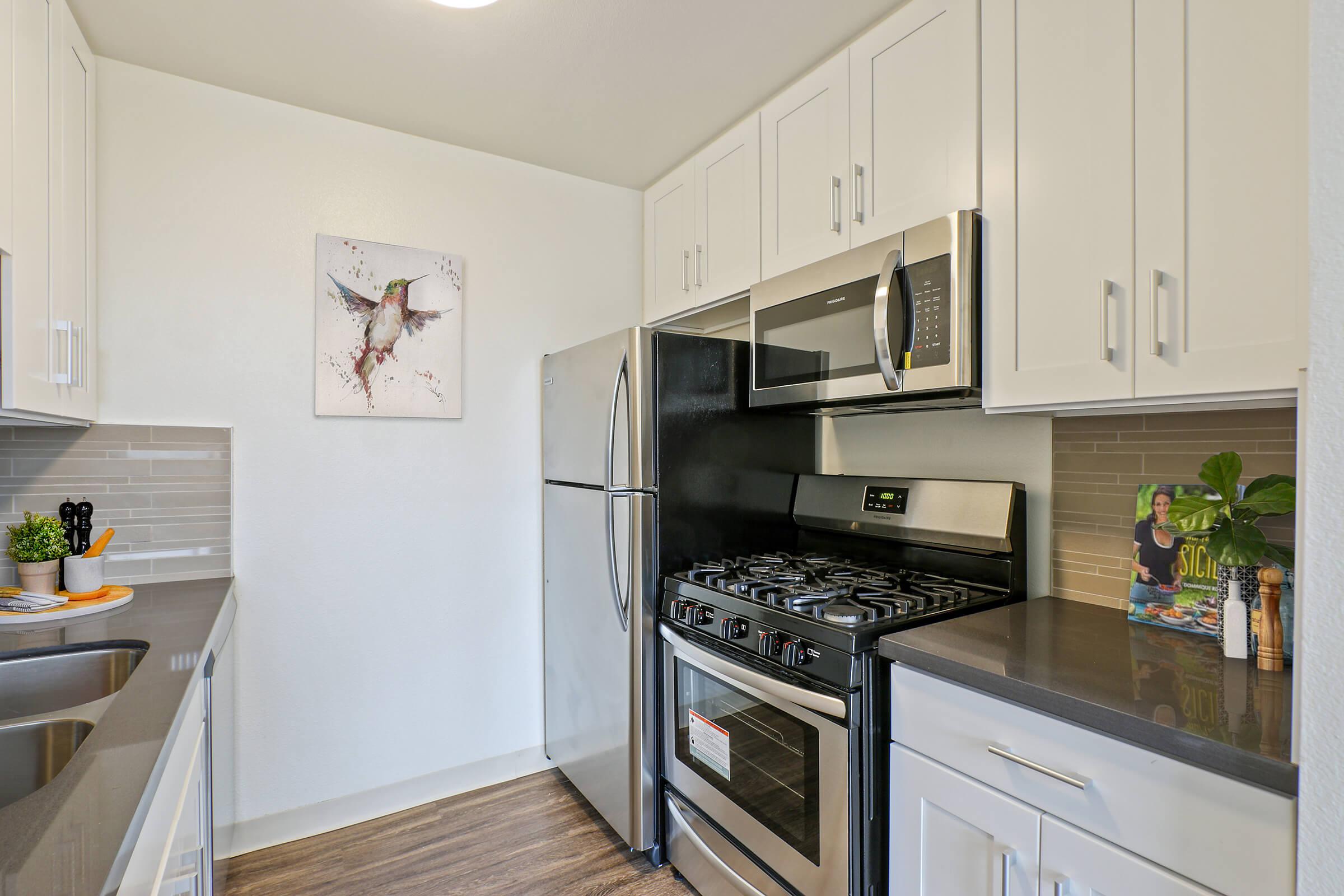 a kitchen with a stove sink and refrigerator