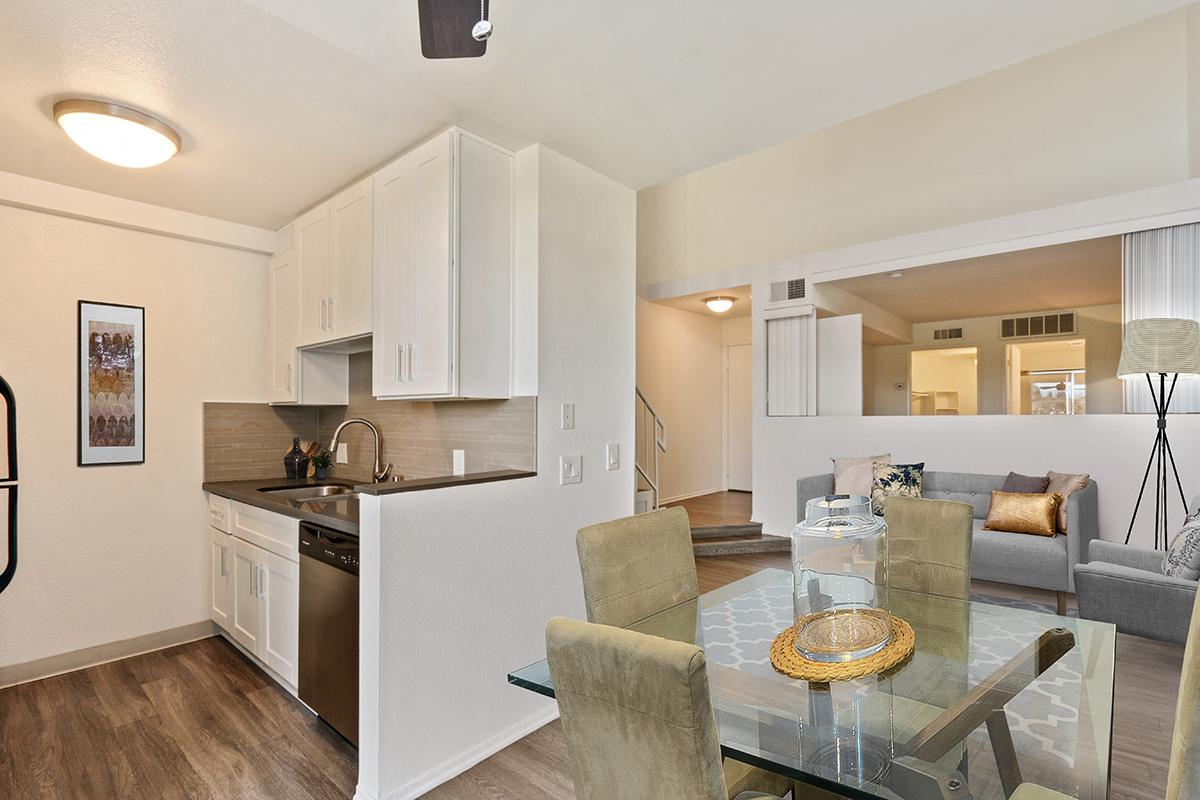 a large kitchen with stainless steel appliances and wooden cabinets