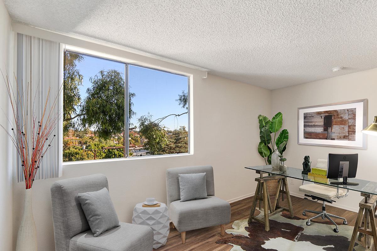 a living room filled with furniture and a large window