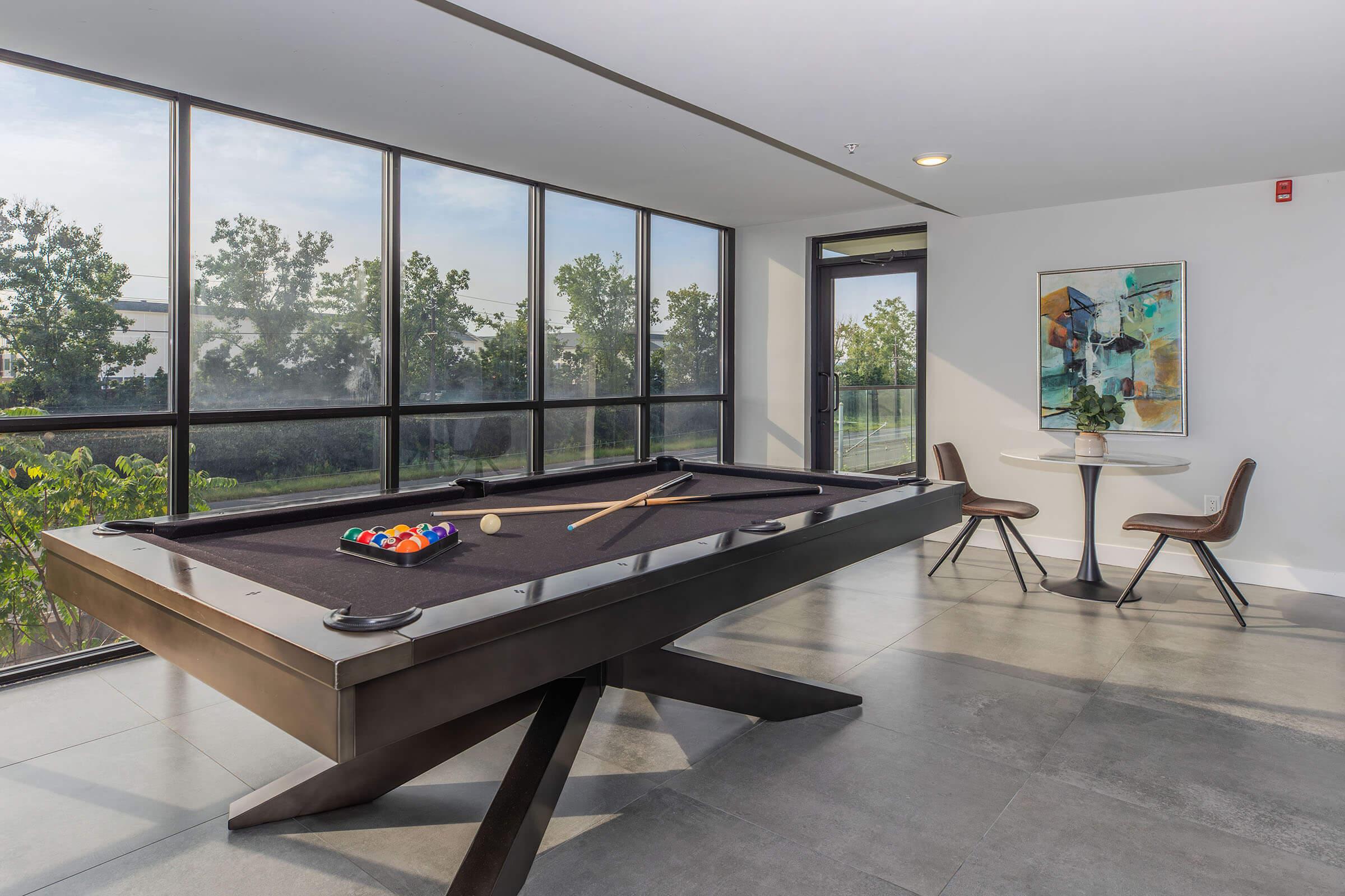 a living room filled with furniture and a large window