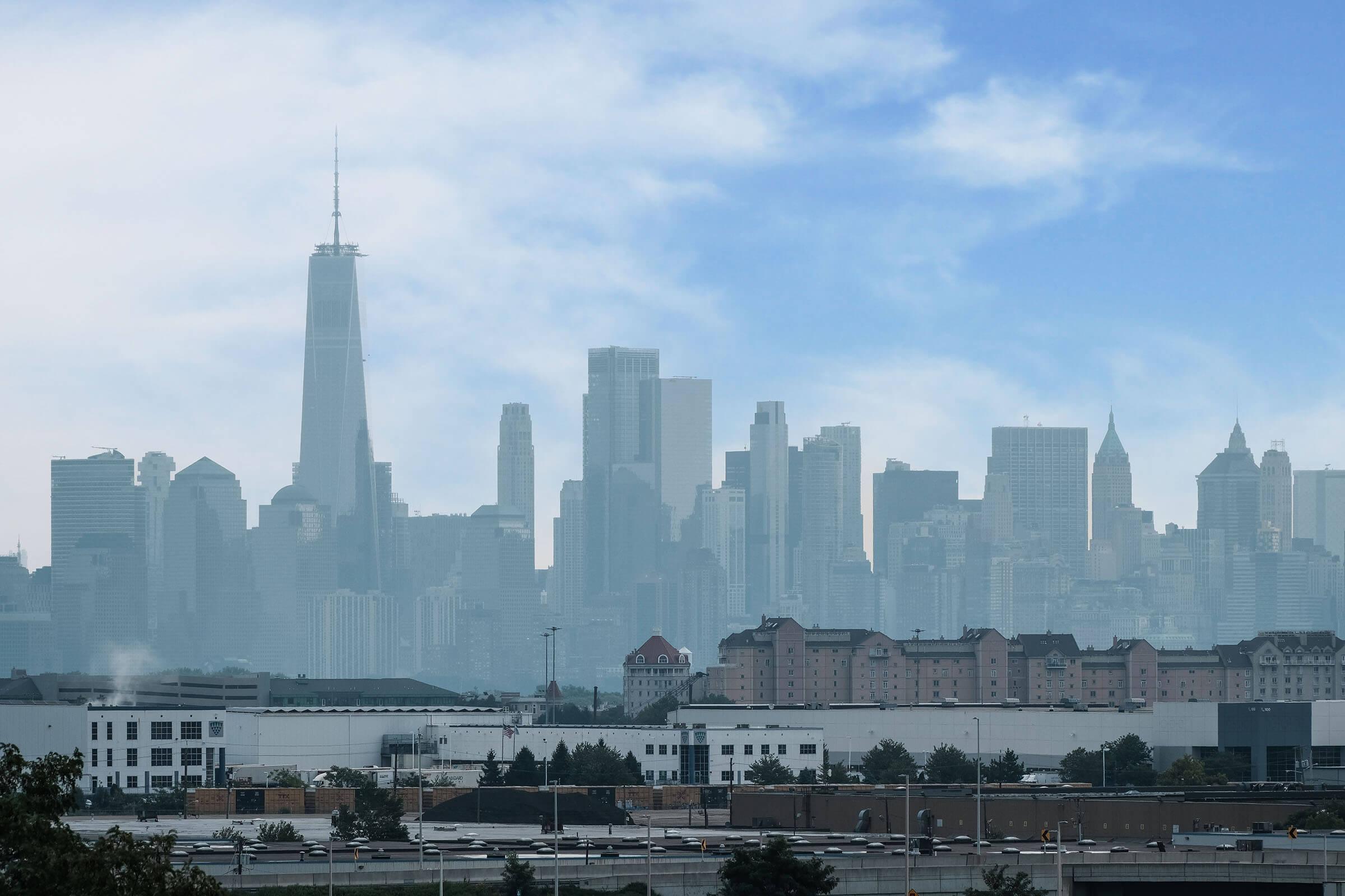 a large body of water with a city in the background