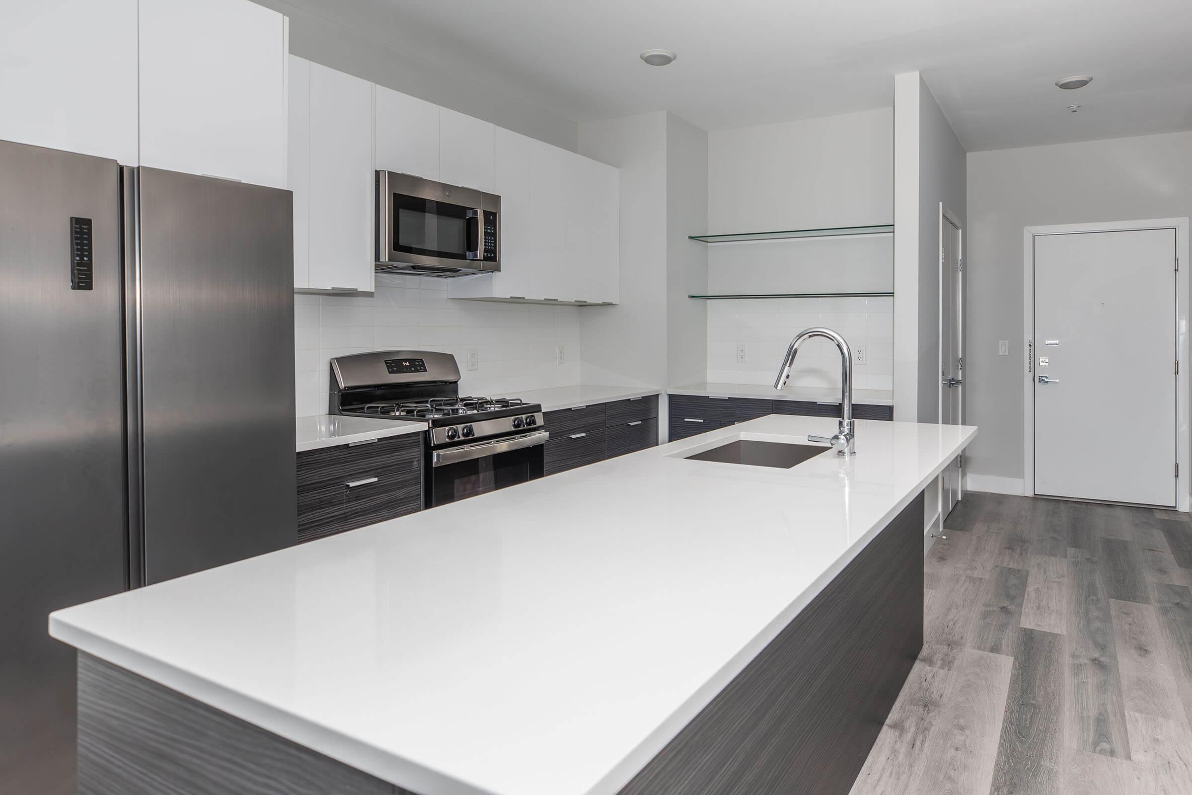 a kitchen with a sink and a mirror