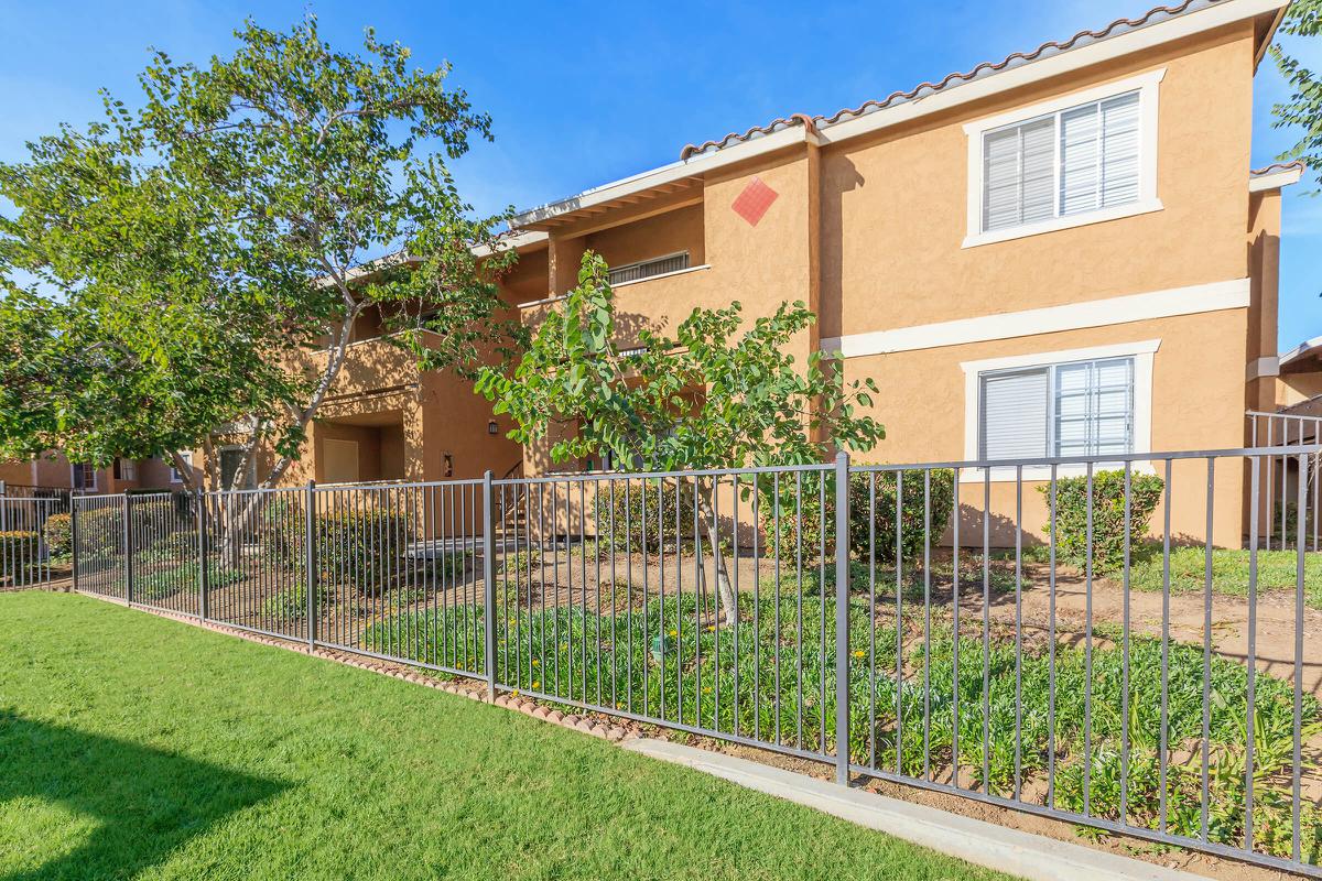 a house with a fence in front of a building