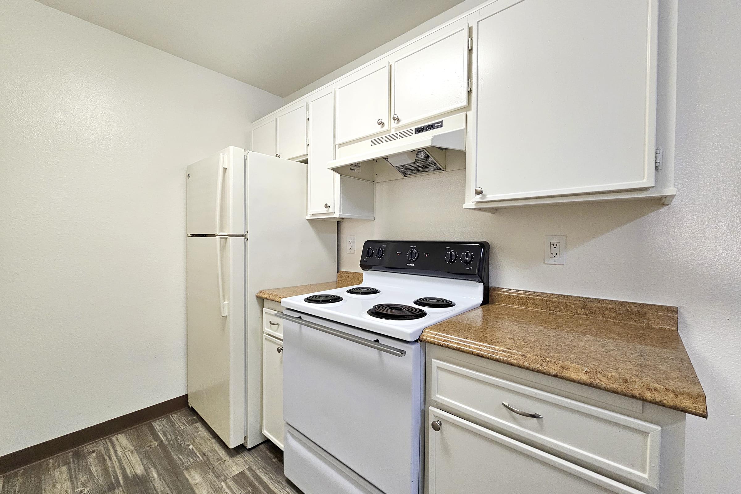 a stove top oven sitting inside of a kitchen