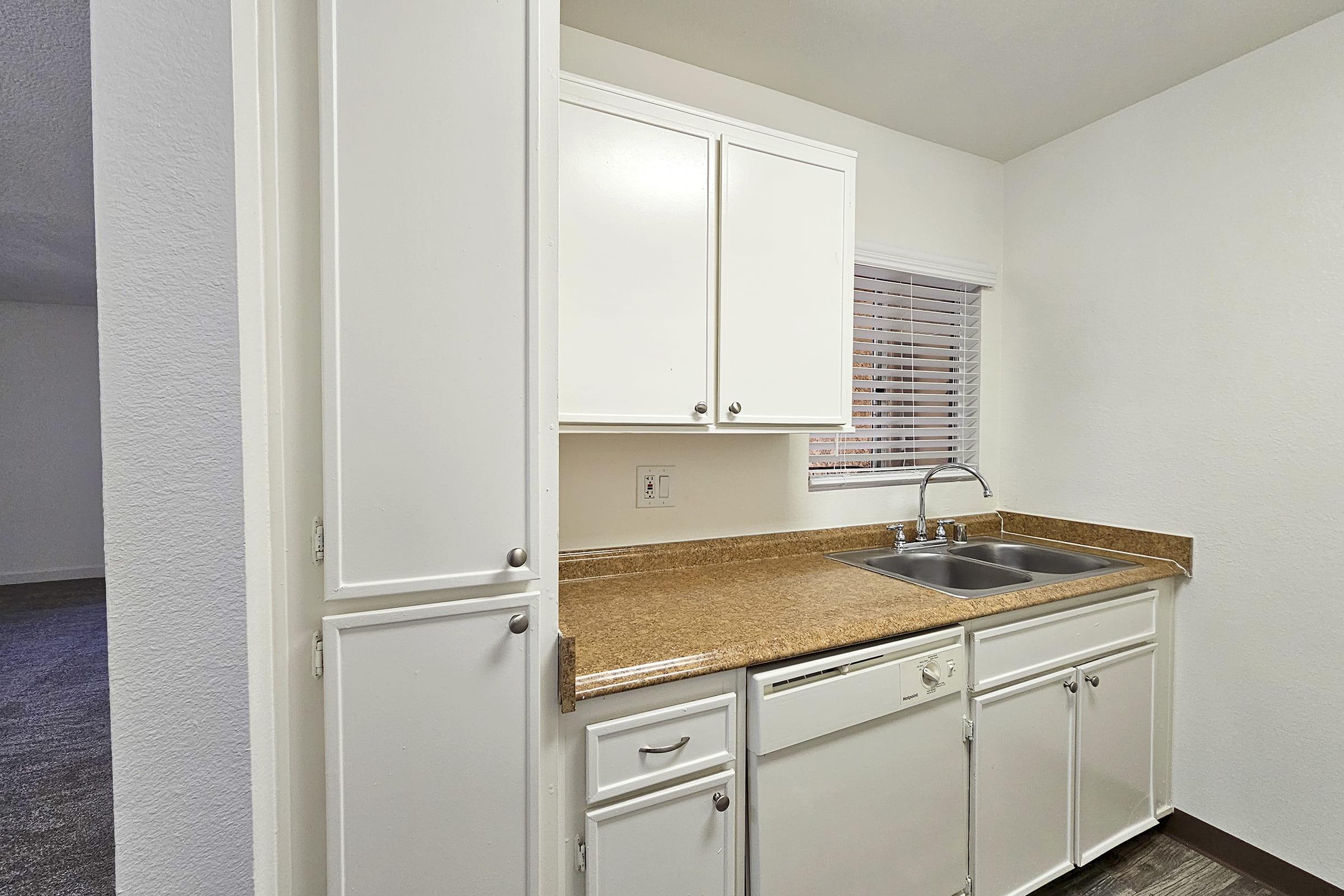 a kitchen with a sink and a mirror