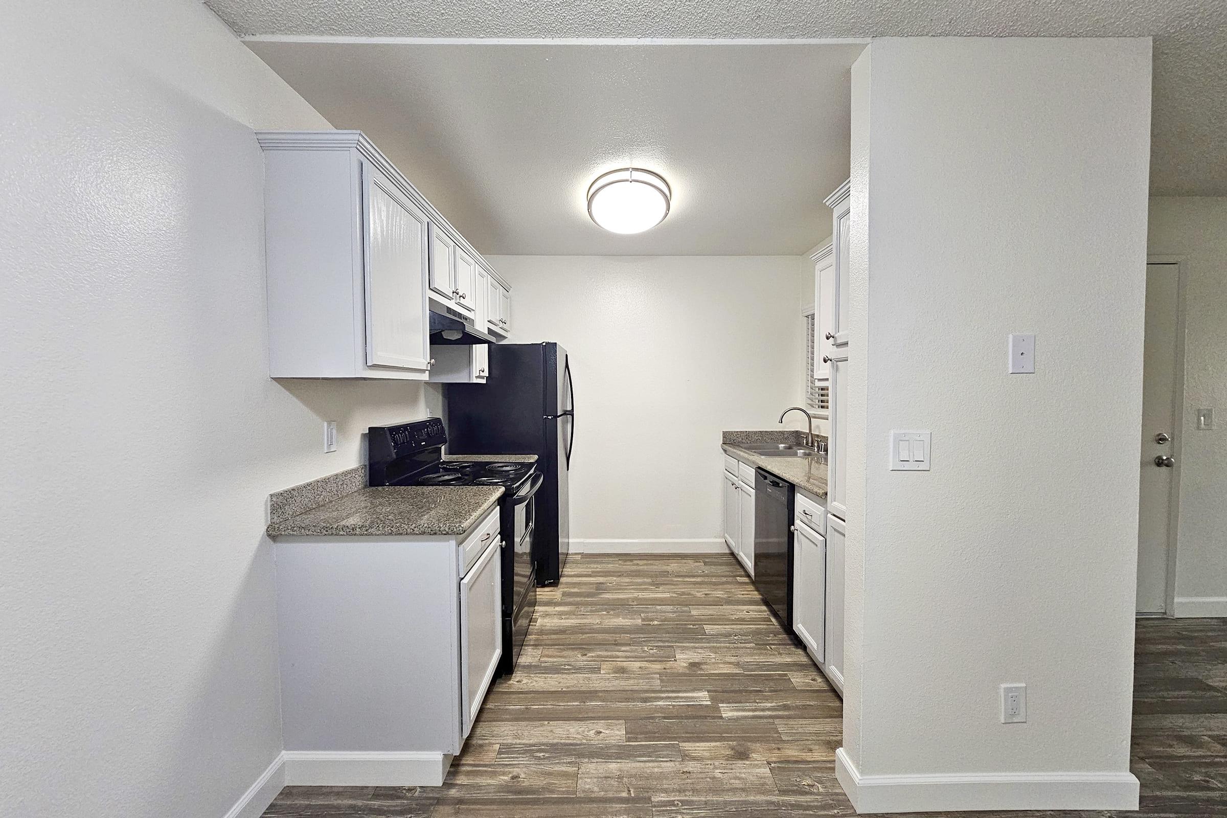 a kitchen with a stove and a refrigerator