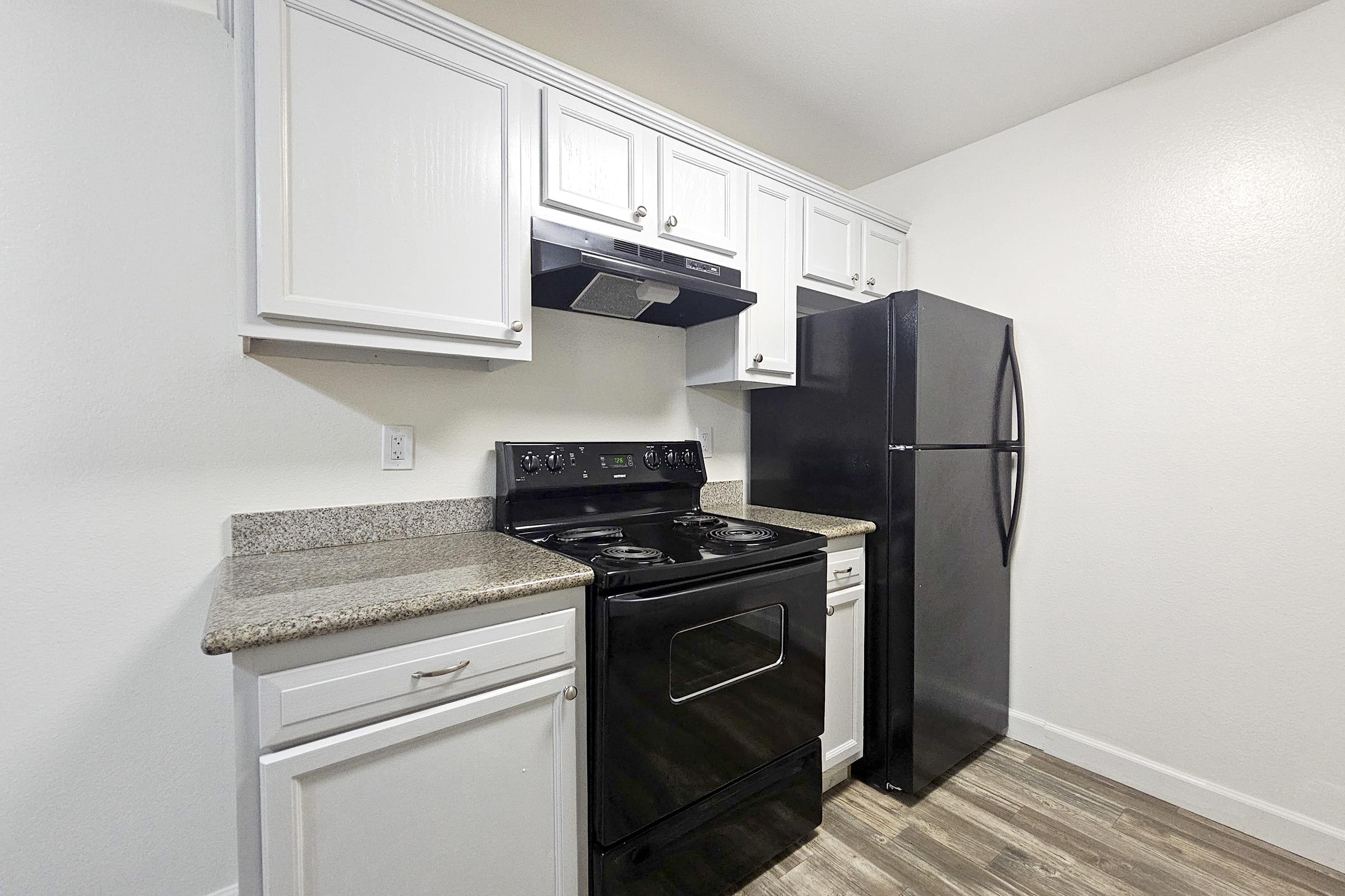 a kitchen with a stove and a refrigerator